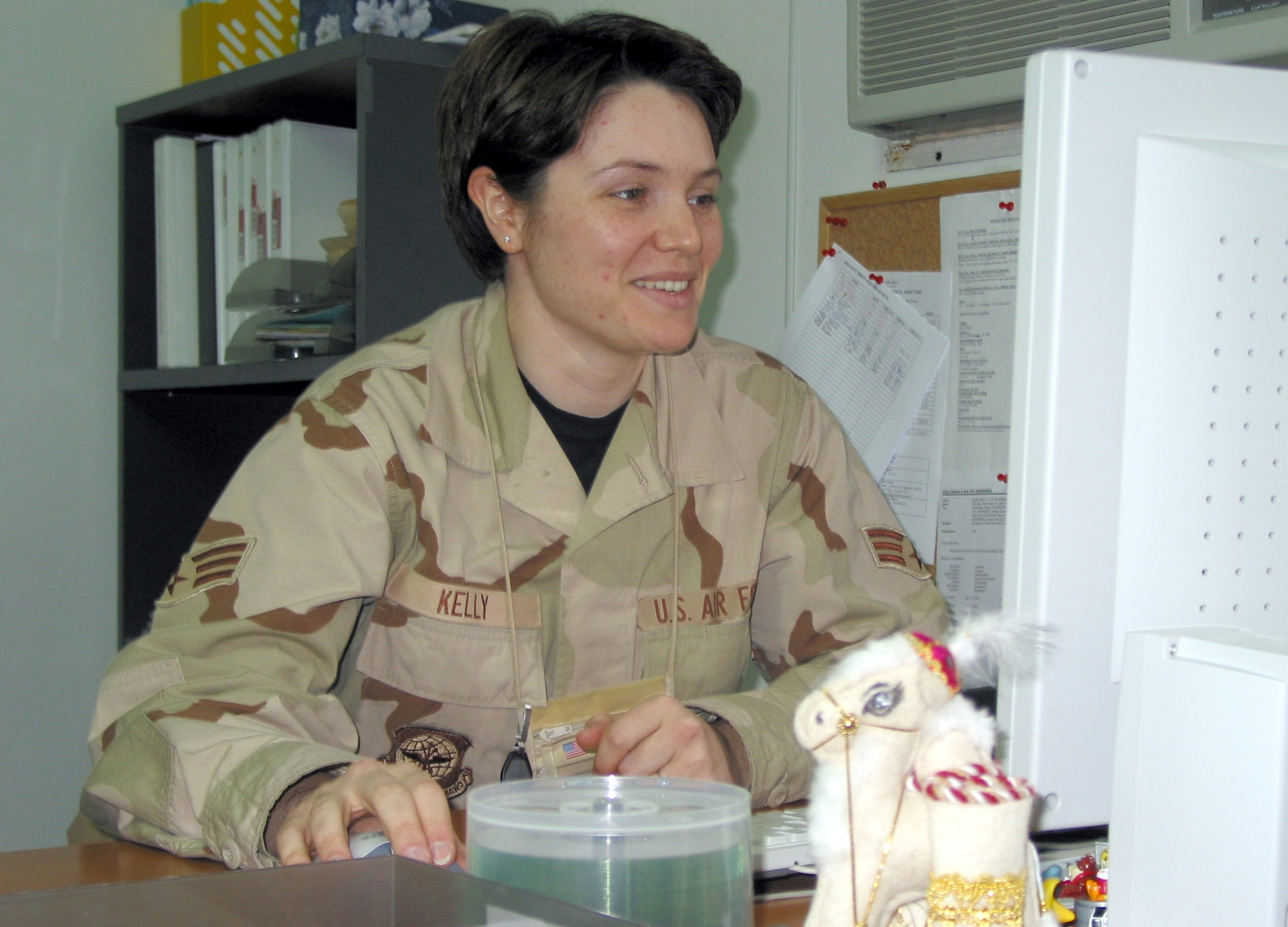 MANAS AIR BASE, Kyrgyzstan (AFPN) -- Senior Airman Deliana Kelly works at her desk in the 376th Mission Support Group's headquarters.  Airman Kelley came to America from Bulgaria in 1999, and has since received her citizenship after joining the Air Force.  (U.S. Air Force photo by Tech. Sgt. William J. Seabrook Jr.)