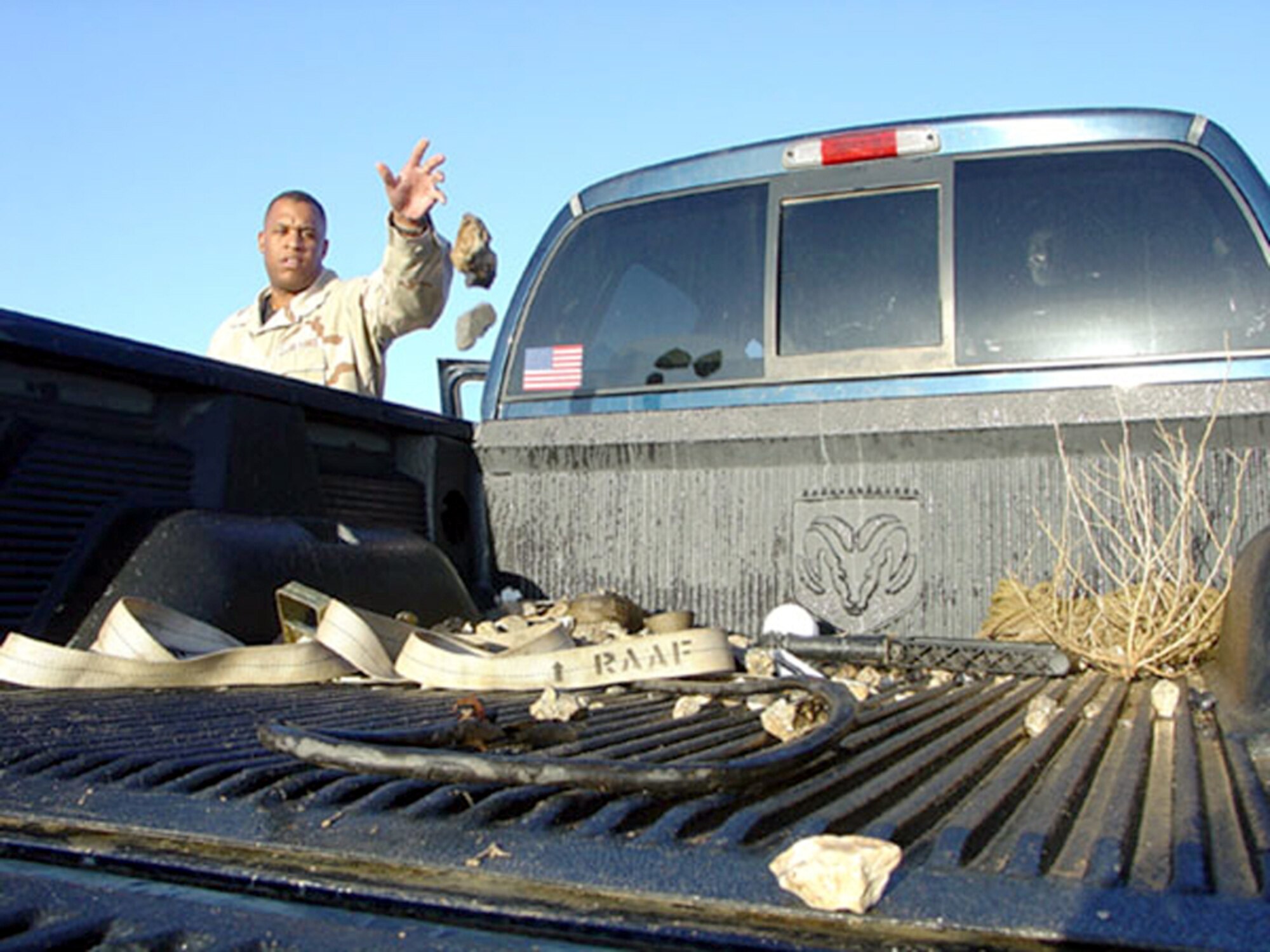 TALLIL AIR BASE, Iraq -- Master Sgt. George Sims removes debris from the runway here.  More than 1,600 pounds of debris has been removed from the airfield since November.  Sergeant Sims is the 332nd Expeditionary Operations Support Squadron airfield manager, deployed here from Langley Air Force Base, Va.  (U.S. Air Force photo by Staff Sgt. Chris Stagner)