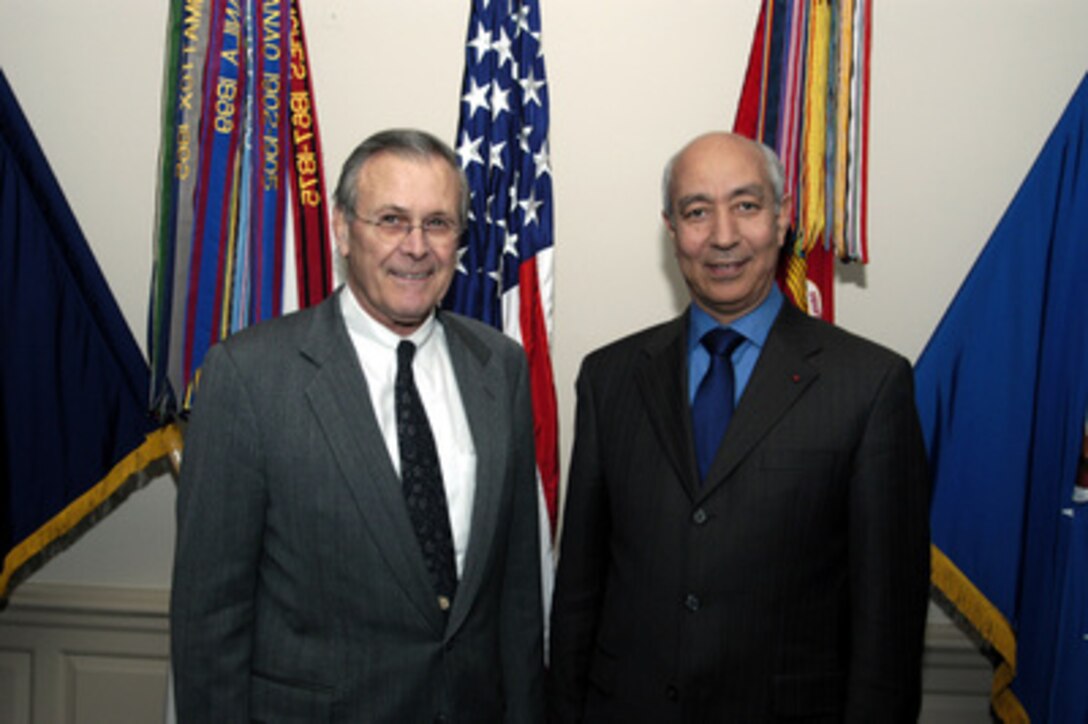 Secretary of Defense Donald H. Rumsfeld and Prime Minister Driss Jettou of the Kingdom of Morocco pose for photographs prior to their meeting in the Pentagon on Jan. 8, 2004. The two leaders are meeting to discuss defense issues of mutual interest. 