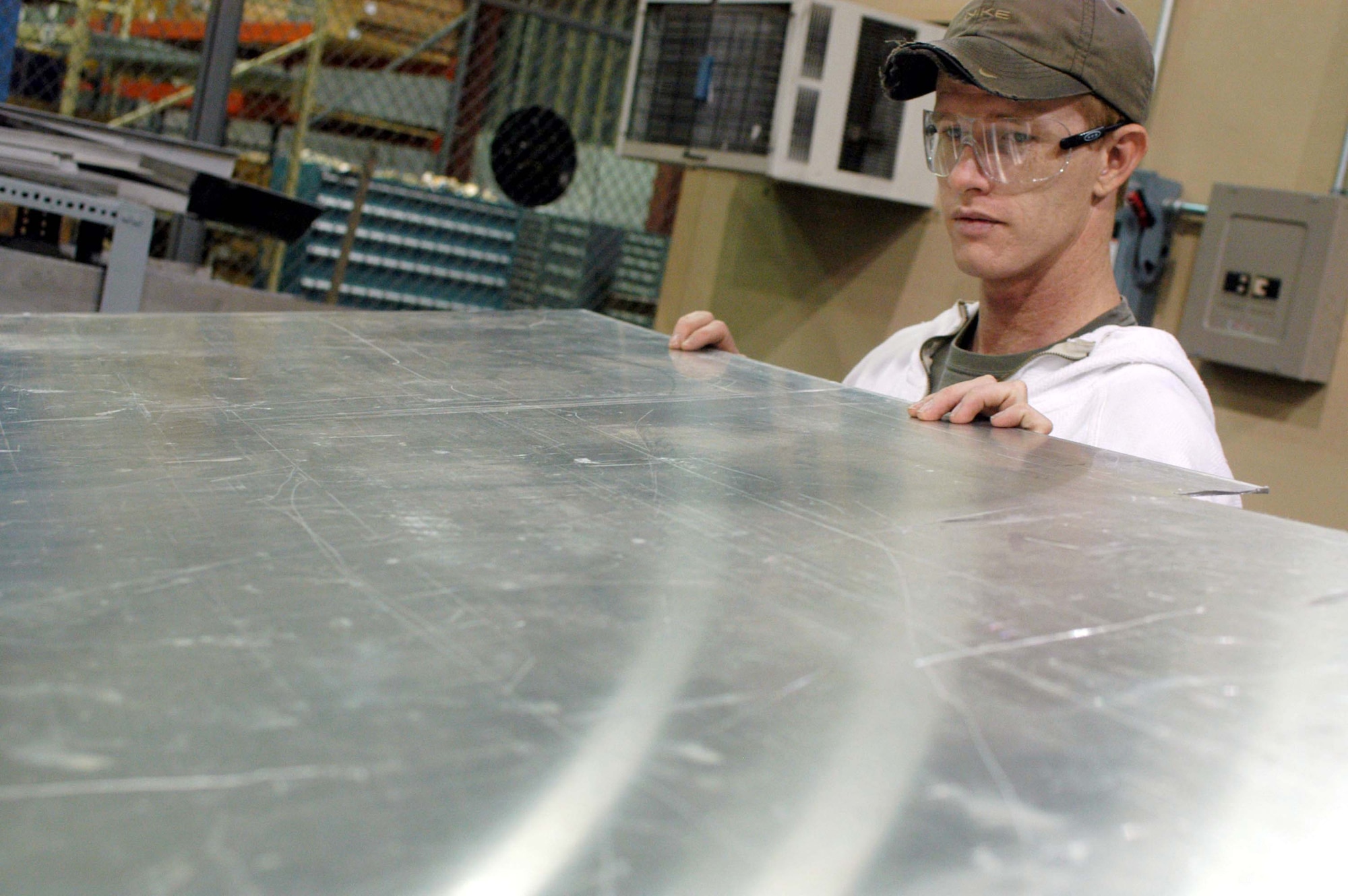 ROBINS AIR FORCE BASE, Ga. -- George Wells pulls stock sheet metal for upcoming repairs.  Mr. Wells is one of 53 who works in the maintenance directorate's sheet metal shop here.  (U.S. Air Force photo by Sue Sapp)