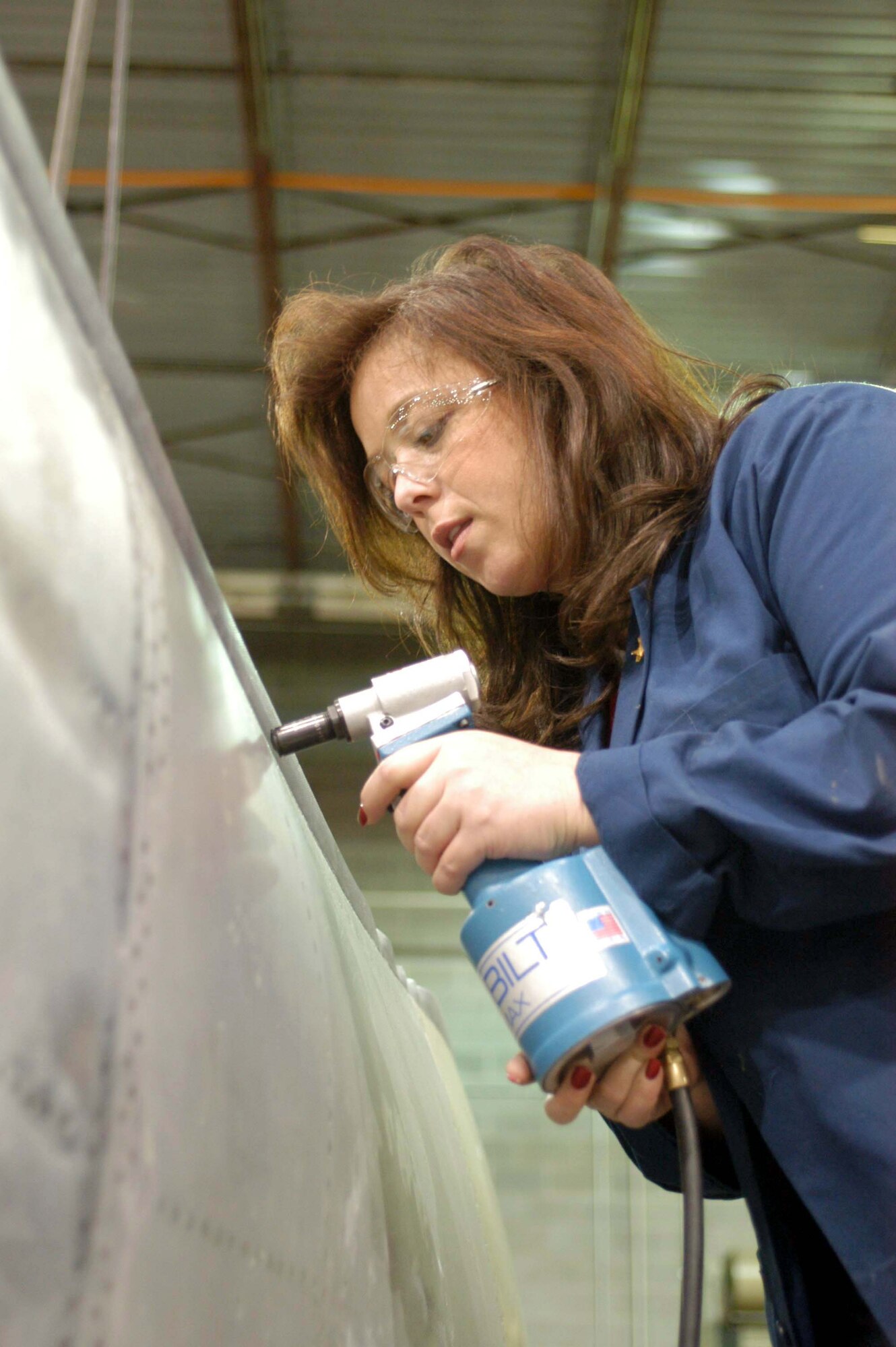 ROBINS AIR FORCE BASE, Ga. -- Patricia Pickett rivets exterior peripheral seals around an F-15 Eagle fuel tank.  She is one of 53 who works in the maintenance directorate's sheet metal shop here.  (U.S. Air Force photo by Sue Sapp)