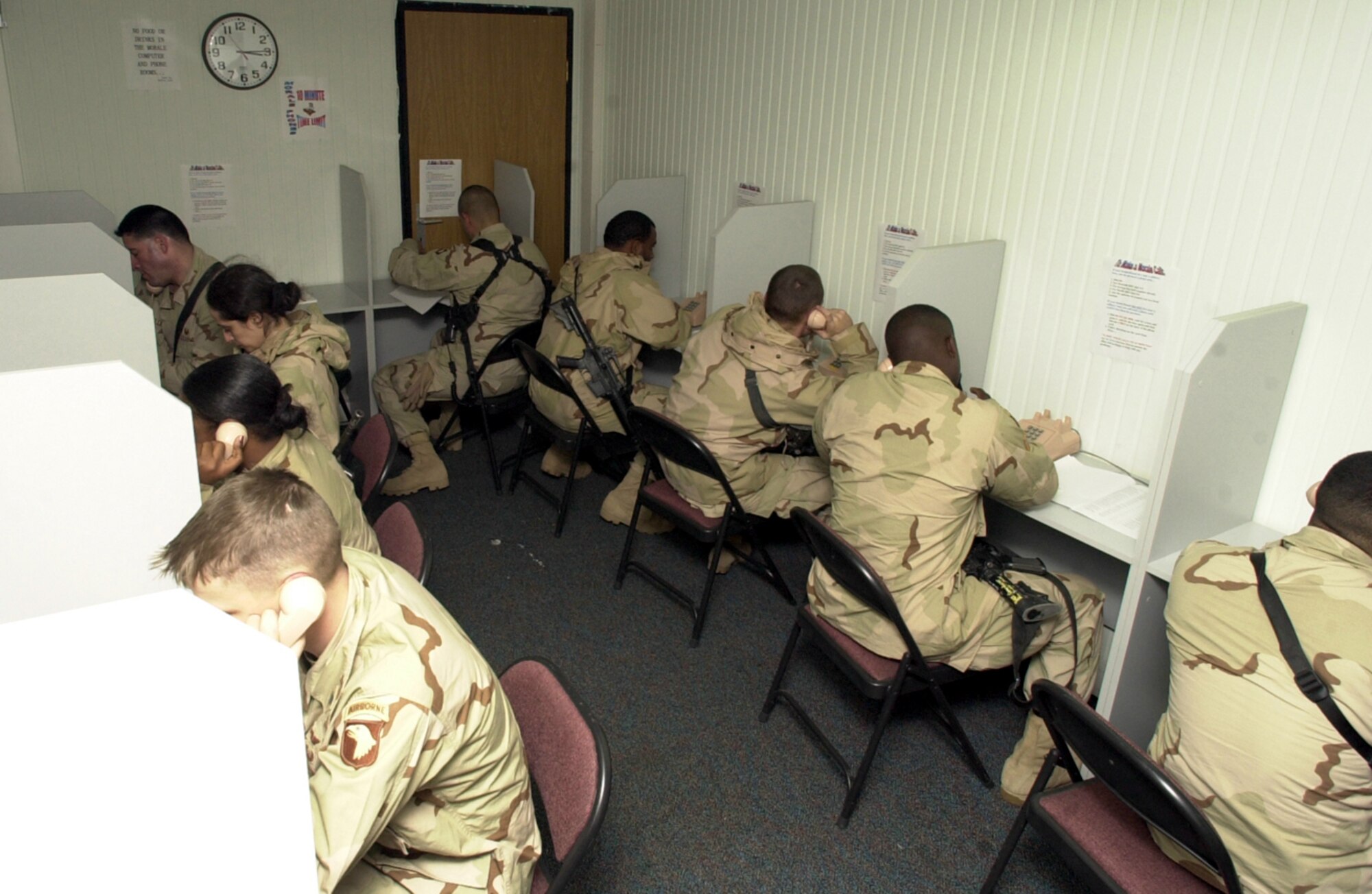 INCIRLIK AIR BASE, Turkey -- U.S. soldiers place morale calls in a terminal specially equipped to make wait for departing aircraft more tolerable.  Thousands of soldiers are transiting through the base during a large-scale Army troop changeover in Southwest.  (U.S. Air Force photo by Airman 1st Class Dallas Edwards)