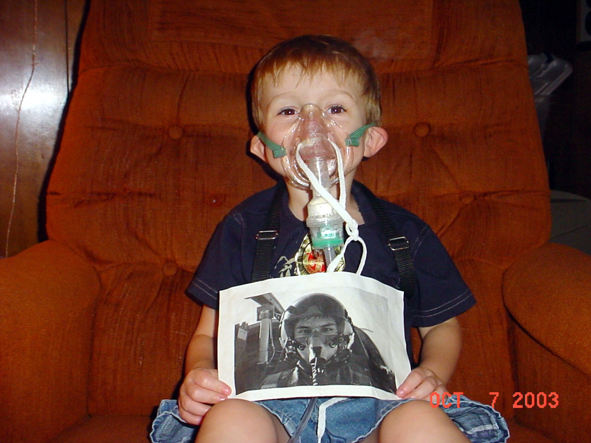 NICEVILLE, Fla. -- Blake Henderson, 4, shares his photo of Capt. James Dykas during a treatment in October.  The picture of Captain Dykas, a B1-B Lancer pilot, helped Blake accept wearing the mask he needs to take nebulizer treatments.  (Courtesy photo)