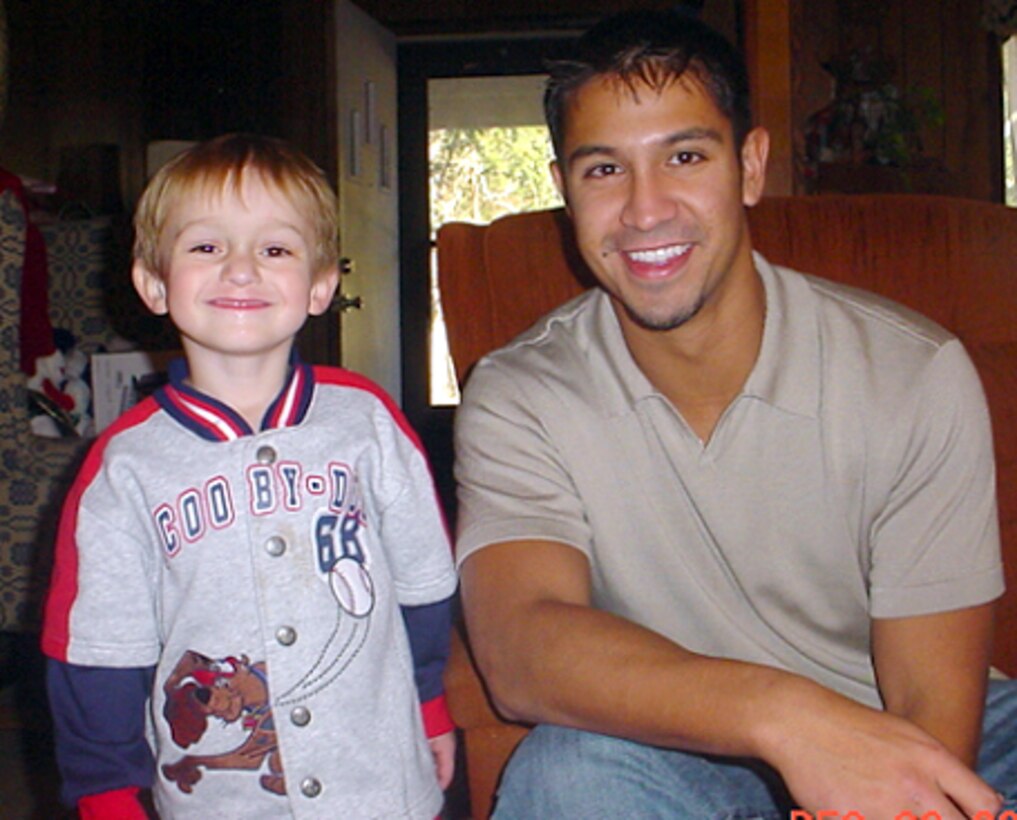 NICEVILLE, Fla. -- Capt. James Dykas poses with Blake Henderson, 4, recently.  Blake uses a picture of the captain wearing his oxygen mask to accept that he must wear a mask for nebulizer treatments.  Captain Dykas is a B1-B Lancer pilot at Ellsworth Air Force Base, S.D.  (Courtesy photo)