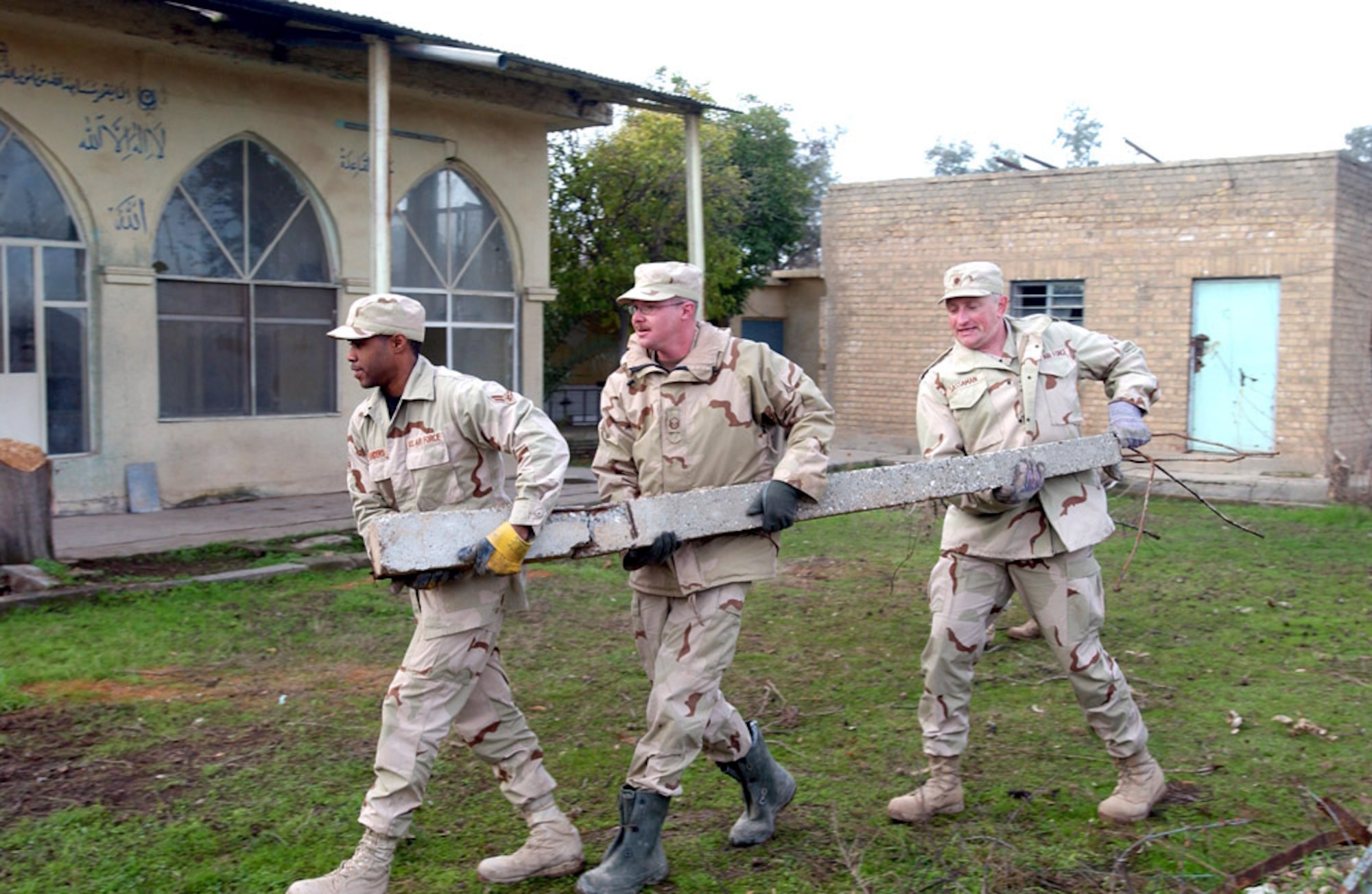 KIRKUK AIR BASE, Iraq -- Airmen remove a concrete pillar during the Jan. 11 cleanup effort to help restore a mosque here.  Project volunteers represent several 506th Air Expeditionary Group units here.  (U.S. Air Force photo by Tech. Sgt. Robert Wieland)