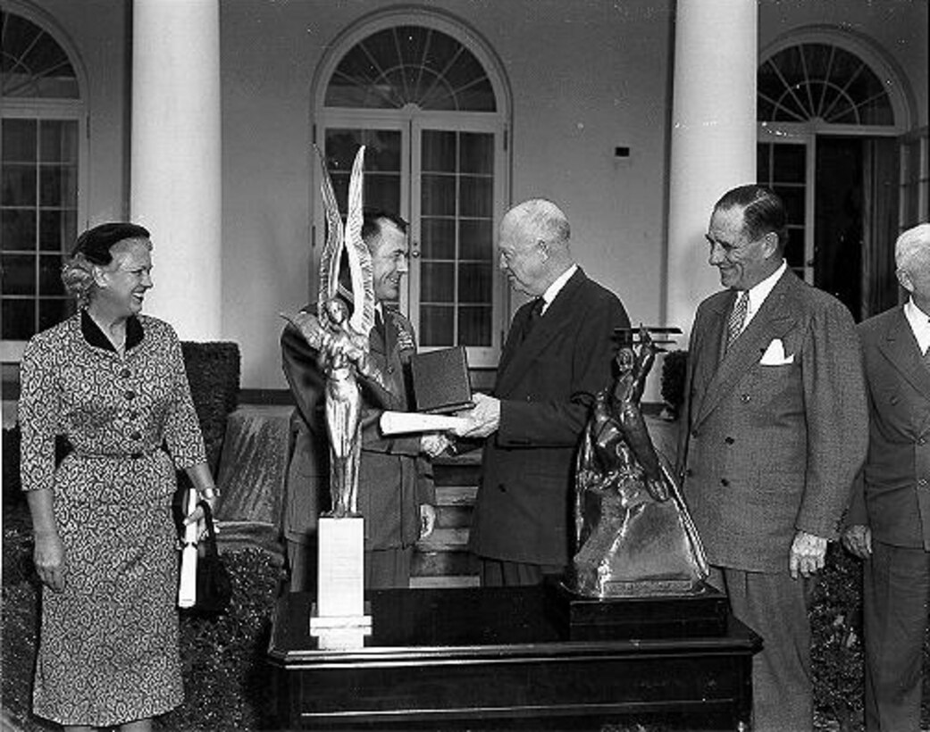 Jackie Cochran and Chuck Yeager being presented with the Harmon International Trophies by President Dwight D. Eisenhower. (Photo courtesy Air Force Flight Test Center History Office)