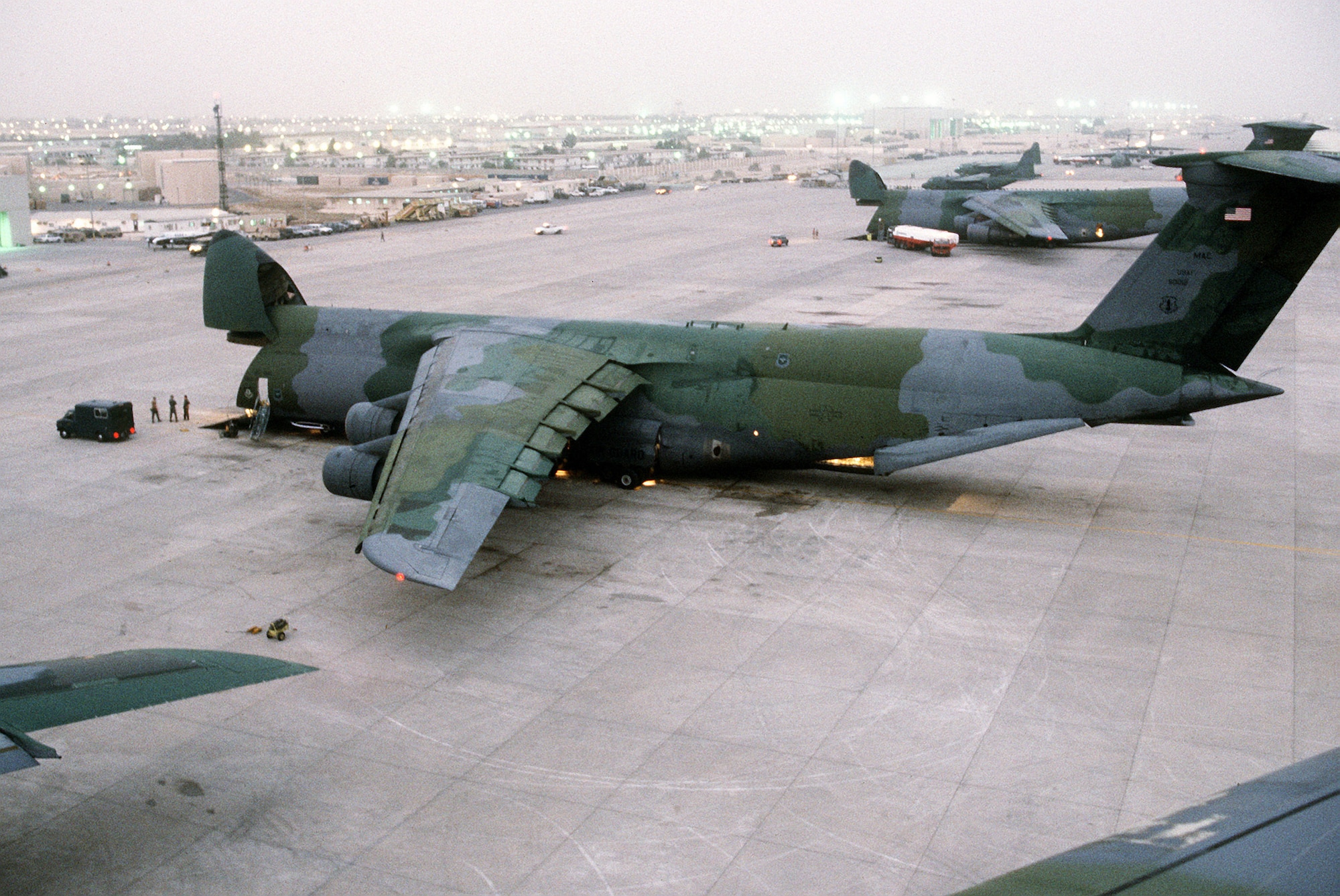 1990's -- Supplies and equipment are unloaded through the nose of a C-5A Galaxy transport aircraft of the U.S. Air Force Reserve, Military Airlift Command, in support of Operation Desert Shield.  