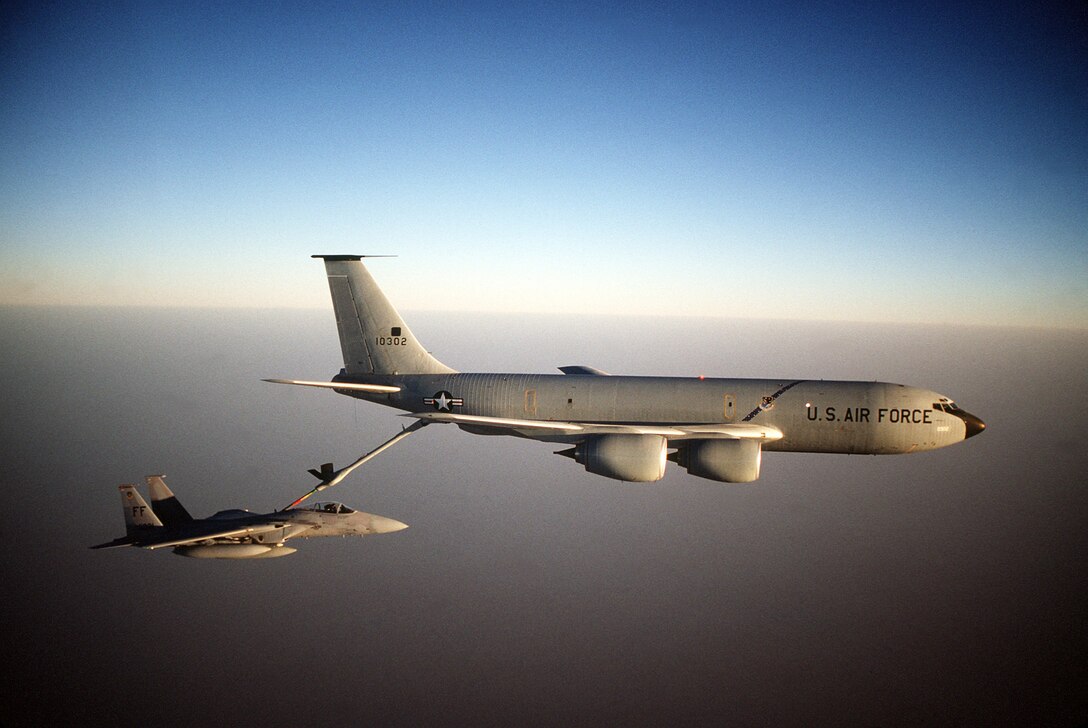 1990's -- A 1st Tactical Fighter Wing F-15C Eagle aircraft refuels from a KC-135R Stratotanker aircraft while on a combat patrol near the Iraqi border during Operation Desert Shield.  