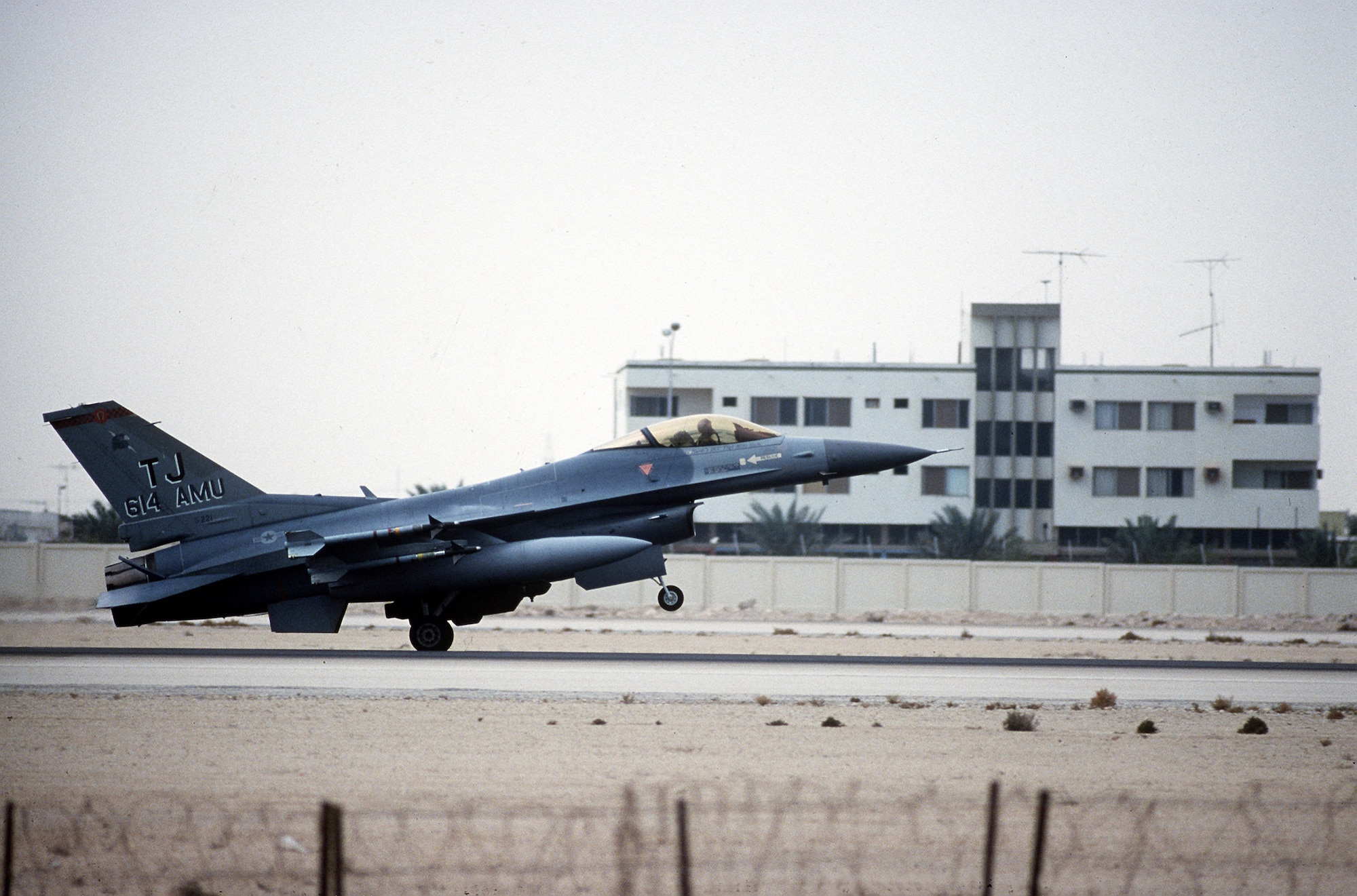 1990's -- A 614th Tactical Fighter Squadron F-16C Fighting Falcon aircraft lands following a mission on the first daylight strike against Iraqi targets during Operation Desert Storm.  The aircraft is armed with AIM-9 Sidewinder missiles.  