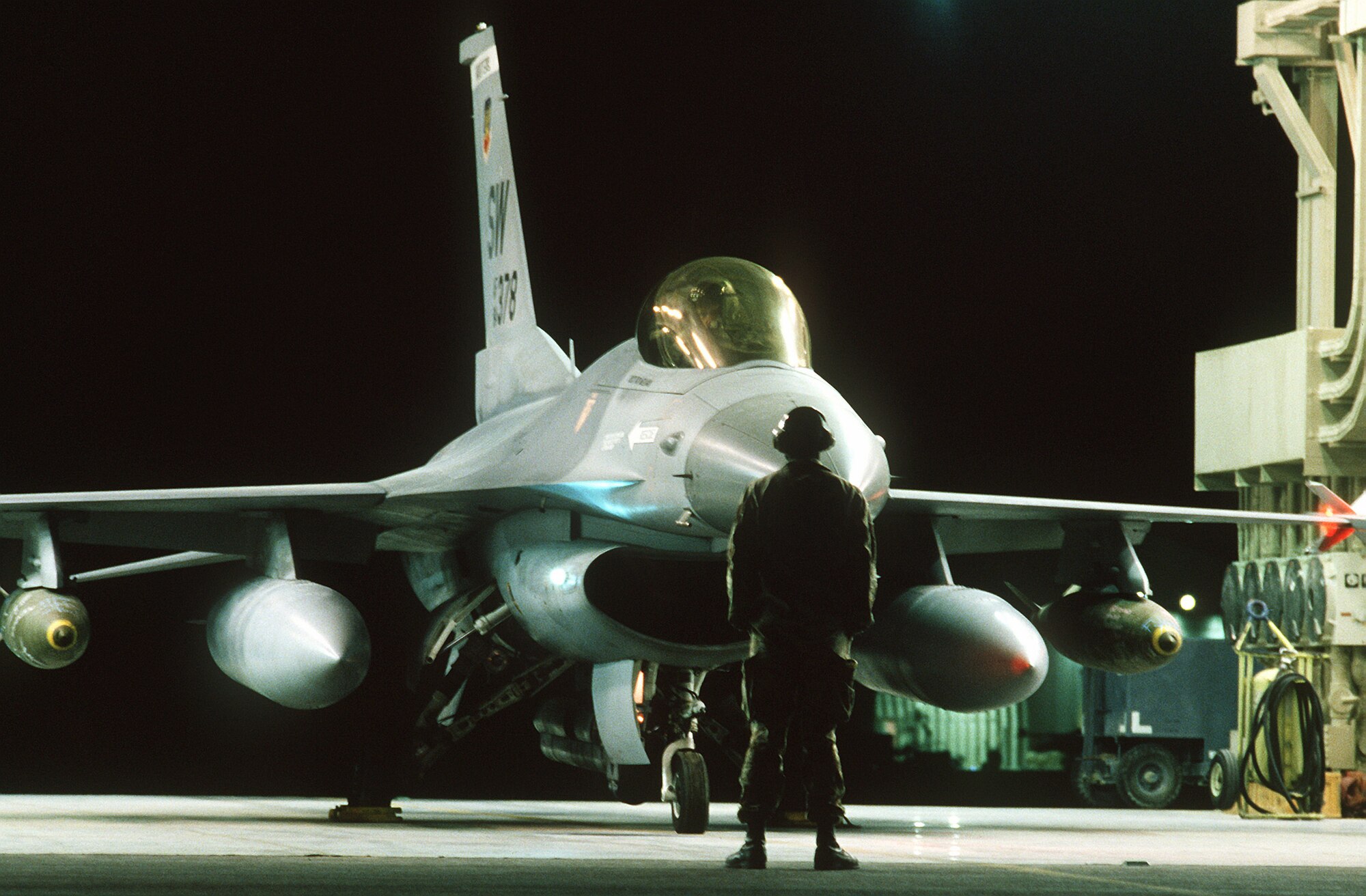 1990's -- Sgt. Ken Mahaley, crew chief, 17th Avionics Squadron, launches an F-16C Fighting Falcon fighter aircraft of the 363rd Tactical Fighter Wing, Shaw Air Force Base, S.C., during the first wave of the air attack on Iraq in support of Operation Desert Storm.  The Falcon is armed with Mark 84 2,000-pound bombs mounted under its wings.