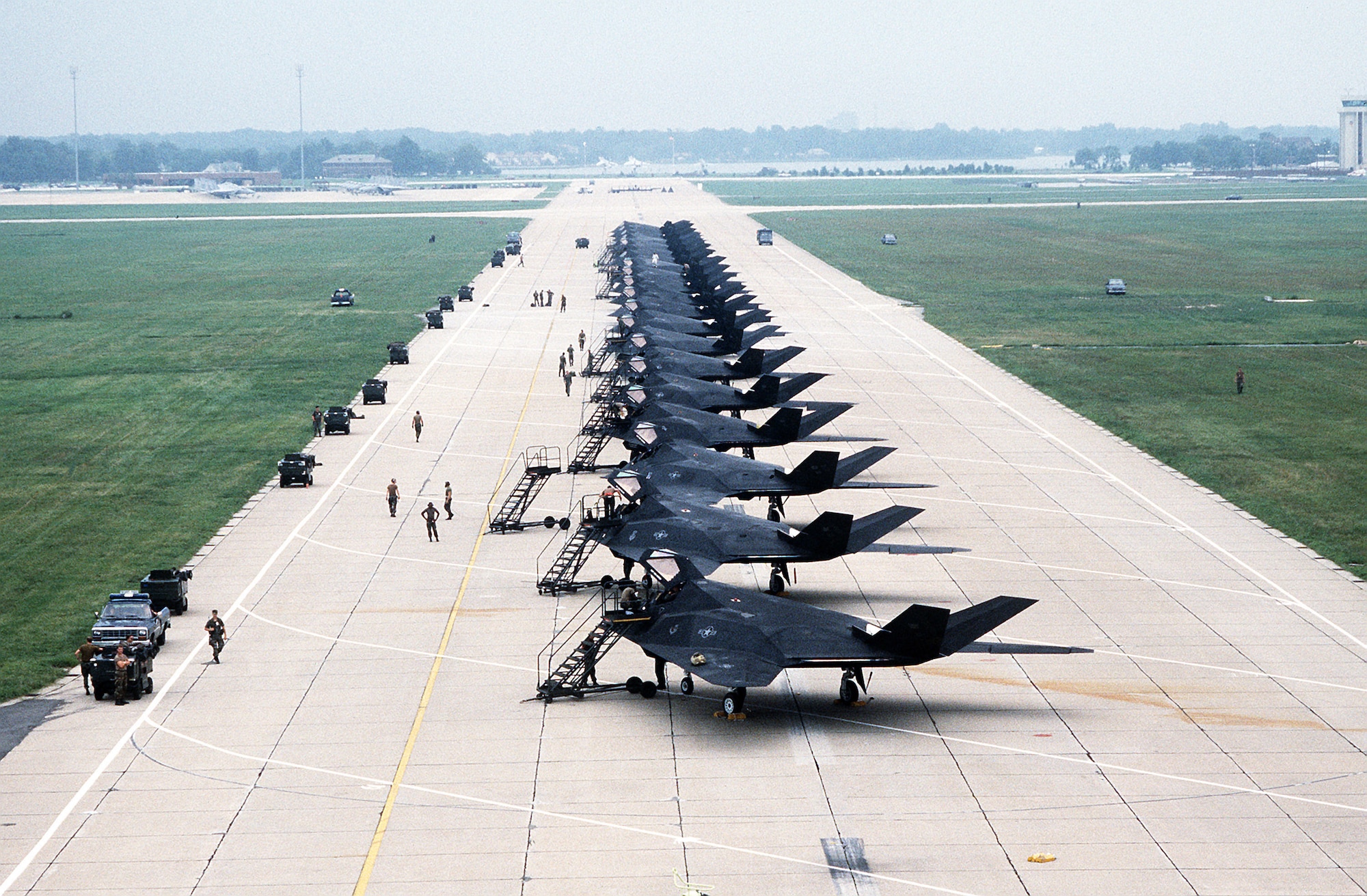 1990's -- Ground crews service the F-117A aircraft of the 37th Tactical Fighter Wing (37th TFW) on the flight line.  The 37th TFW is preparing to deploy to Saudi Arabia for Operation Desert Shield.  