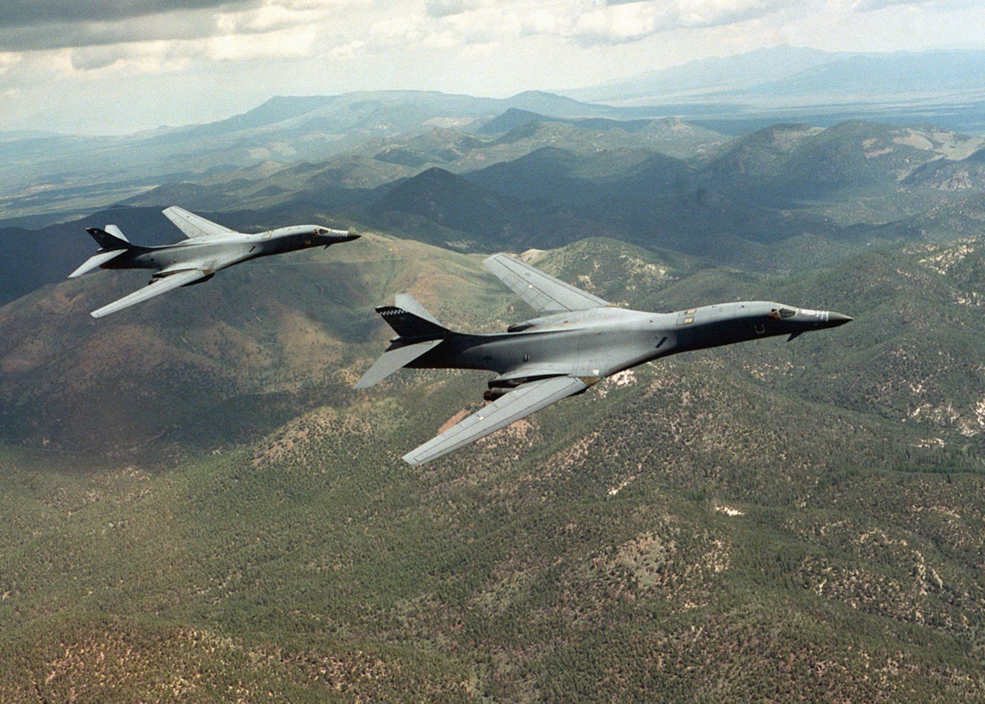 The B-1B is a long-range strategic bomber, capable of flying intercontinental missions without refueling, then penetrating present and future sophisticated enemy defenses. It can perform a variety of missions, including that of a conventional weapons carrier for theater operations. The B-1B's electronic jamming equipment, infrared countermeasures, radar location and warning systems complement its low-radar cross-section and form an integrated defense system for the aircraft. The swing-wing design and turbofan engines not only provide greater range and high speed at low levels but they also enhance the bomber's survivability. Wing sweep at the full-forward position allows a short takeoff roll and a fast base-escape profile for airfields under attack. Once airborne, the wings are positioned for maximum cruise distance or high-speed penetration. (U.S. Air Force photo by Staff Sgt. Steve Thurow)
