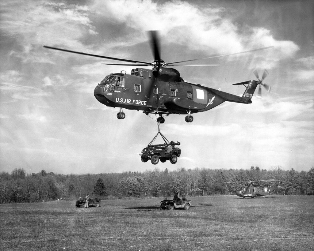 1960's -- FT. LEONARD WOOD, MO -- A U.S. Air Force CH-3C helicopter airlifts a 106mm recoilless rifle mount on a U.S. Army jeep from a rear area into the "battle zone" in support of OZARK forces.  This action was part of a simulated "battle" between the OZARK and SIOUX forces during U.S. Strike Command's Joint Exercise GOLD FIRE I, held in southern Missouri.  10 November 1964 (Official U.S. Strike Command Photo)