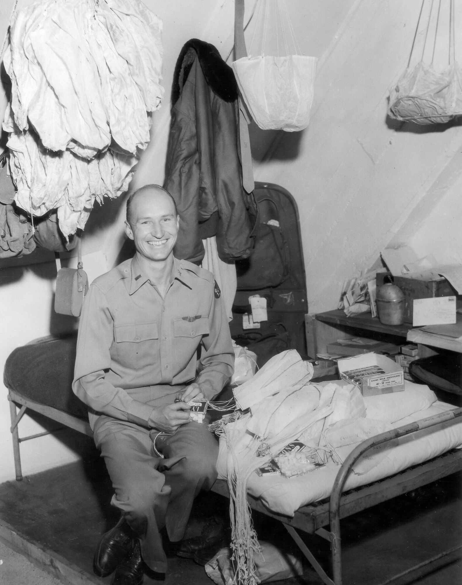 1940's -- 1st Lt. Gail Halvorsen and the 17th Military Air Transport Squadron rig some candy bars to miniature parachutes for German children in Berlin as part of Operation Little Vittles.  As his C-54 plane approaches Tempelhof AB, Germany, he drops the homemade parachutes weighted with American candy bars and gum.