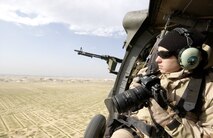 OVER IRAQ (AFPN) -- Staff Sgt. Suzanne Jenkins takes photographs over Iraq from a UH-60L Blackhawk helicopter.  Jenkins is an aerial photographer deployed from the 1st Combat Camera Squadron at Charleston Air Force Base, S.C.  (U.S. Air Force photo by Staff Sgt. Stacy L. Pearsall)