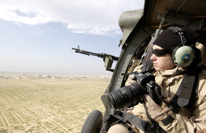 OVER IRAQ (AFPN) -- Staff Sgt. Suzanne Jenkins takes photographs over Iraq from a UH-60L Blackhawk helicopter.  Jenkins is an aerial photographer deployed from the 1st Combat Camera Squadron at Charleston Air Force Base, S.C.  (U.S. Air Force photo by Staff Sgt. Stacy L. Pearsall)