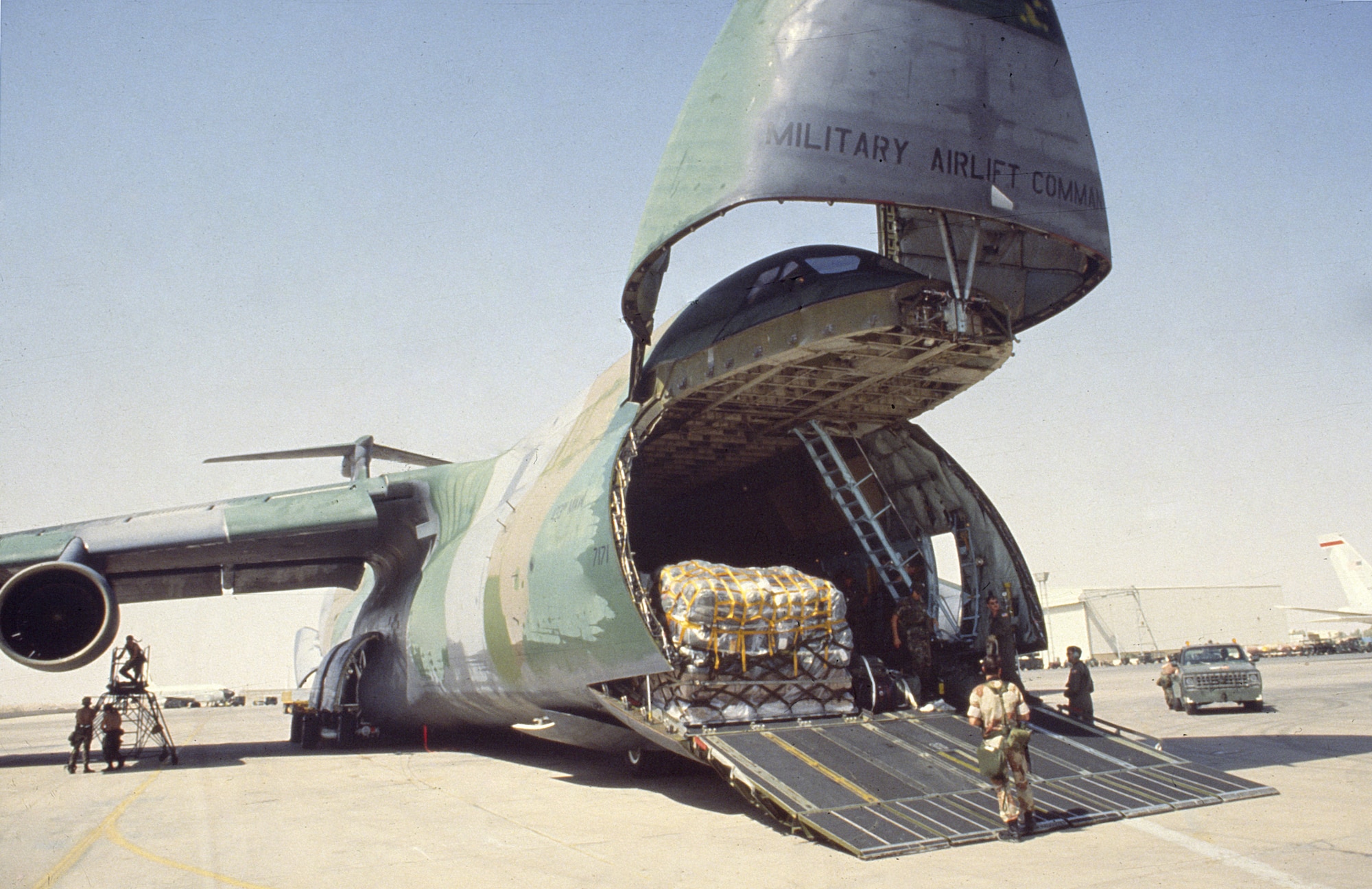 1990's -- A C-5 being loaded for an airlift to deliver cargo to troops in the desert during Desert Storm.