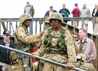 Lansing educators lookon as recruits negotiate obstacles during Lansing?s 2004 workshop. Each year, more than 300 educators from the 9th Marine Corps District travel to a recruit depot and learn more about the Corps.