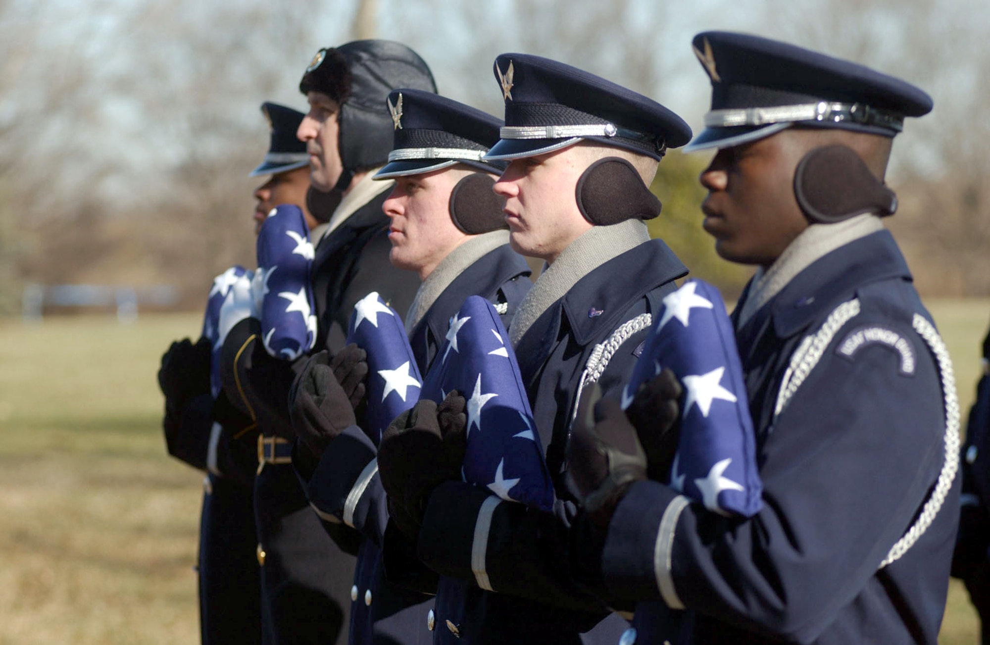 ARLINGTON, Va. -- Members of a joint honor guard carry flags in honor of five military members who were killed when their MH-53M Pave Low helicopter crashed Nov. 23 in Afghanistan.  A full-honor mass funeral was held at Arlington National Cemetery on Jan. 21.  (U.S. Air Force photo by Staff Sgt. Jennifer Gangemi)