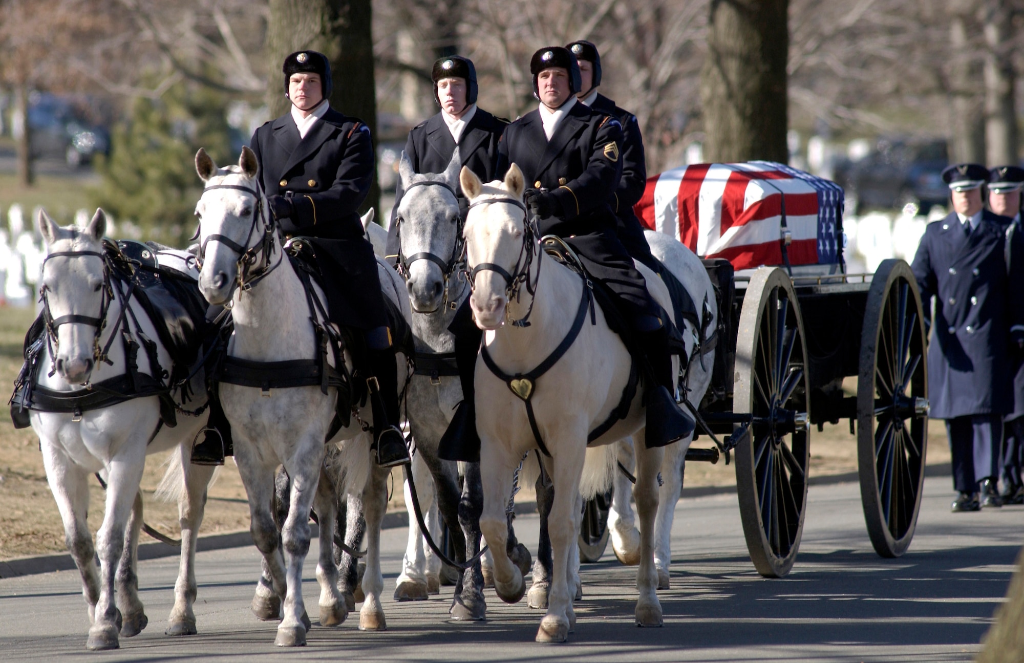 ARLINGTON, Va. -- Five military members who were killed when their MH-53M Pave Low helicopter crashed Nov. 23 in Afghanistan are carried to their final resting place by horse-drawn caisson during a full-honor mass funeral at Arlington National Cemetery on Jan. 21.  (U.S. Air Force photo by Master Sgt.  Jim Varhegyi)