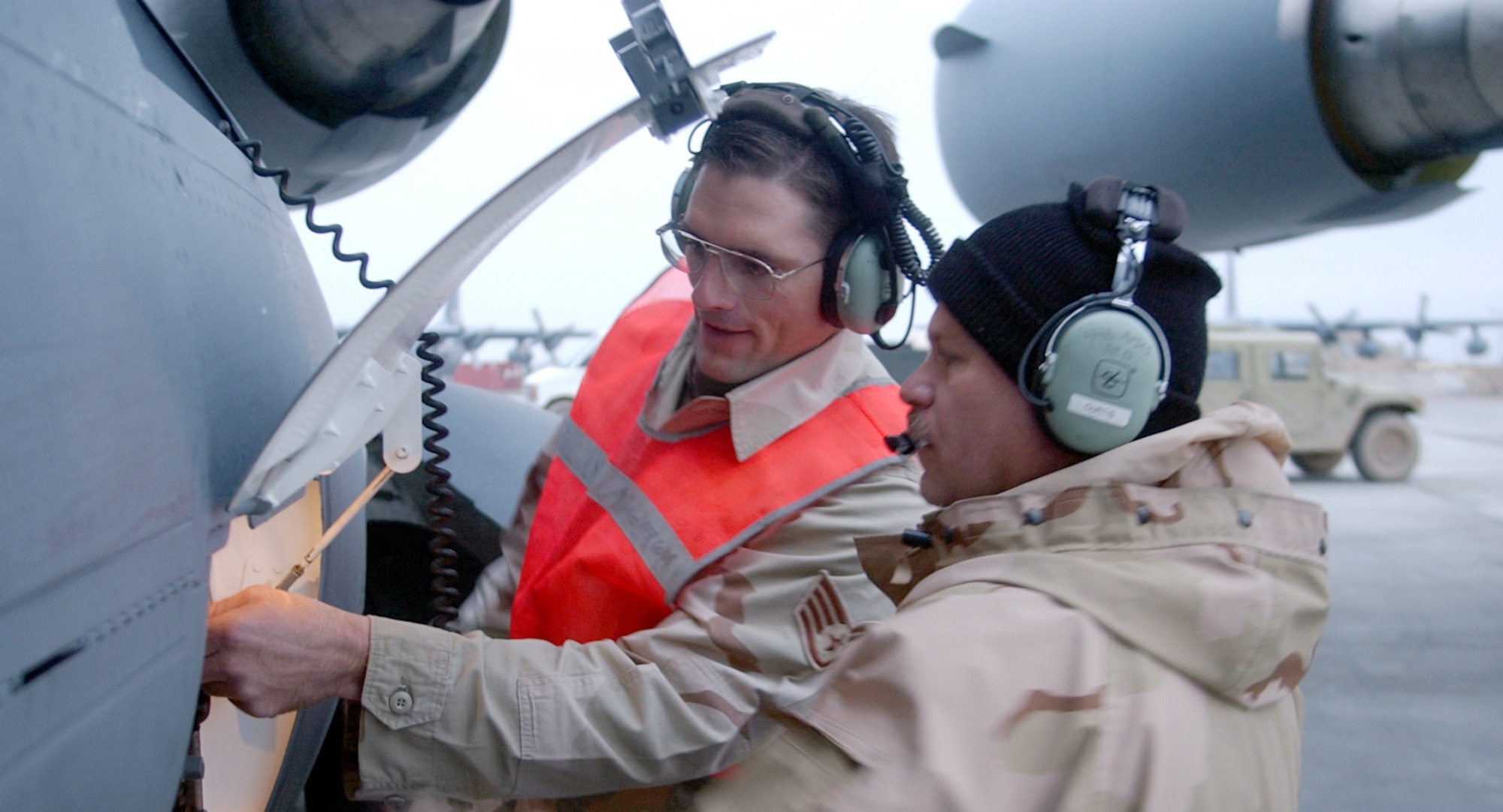 KARSHI-KHANABAD AIRFIELD, Uzbekistan -- Staff Sgt. Shannon Barry (left) and Tech. Sgt. Bill Curtis prepare a visiting C-17 Globemaster III for refueling here.  Both sergeants are transient alert specialists with the 416th Expeditionary Operations Group. (U.S. Air Force photo by Tech. Sgt. Brian Davidson)