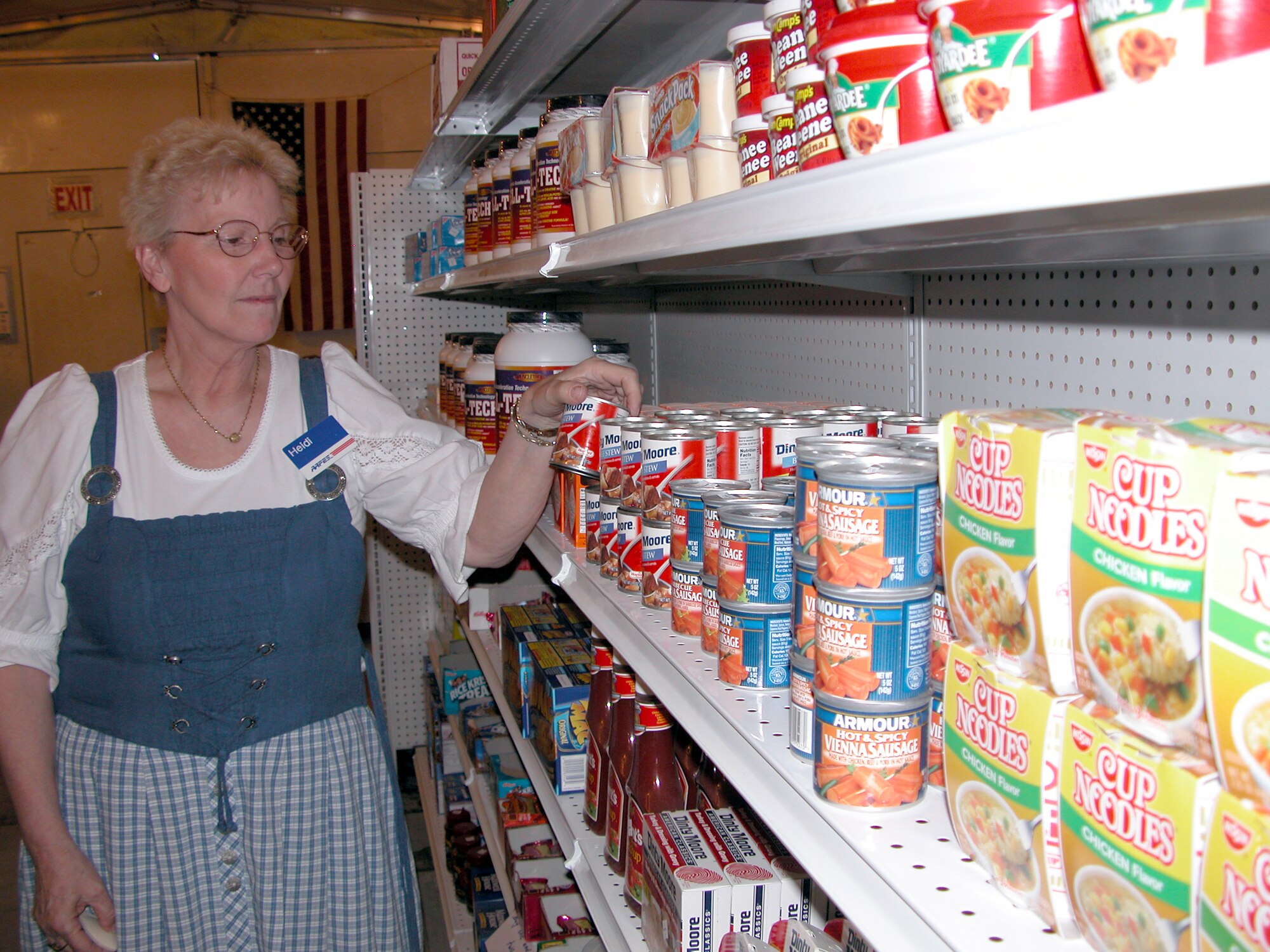 TALLIL AIR BASE, Iraq -- Heidi Stover checks the shelves at the tent city shopette Jan. 22.  She is returning home after a six-month deployment here to support the Army and Air Force Exchange Service's mission.  (U.S. Air Force photo by Tech. Sgt. Bob Oldham)