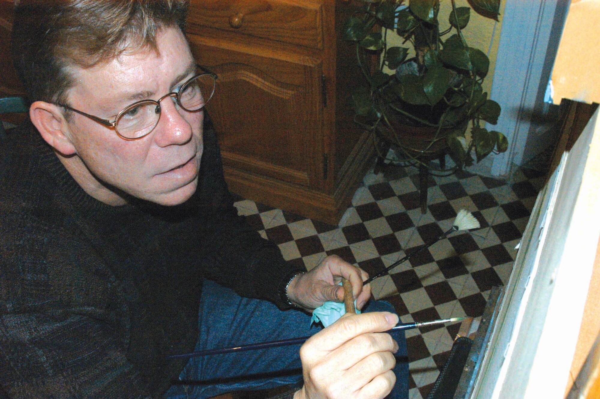 CHIPIONA, Spain -- Master Sgt. Jeffery Kunkle paints a landscape in watercolor at his home.  He recently had a showing of his art at a local art gallery.  Sergeant Kunkle is the quality assurance inspector for the 725th Air Mobility Squadron in Rota.  (Courtesy photo)