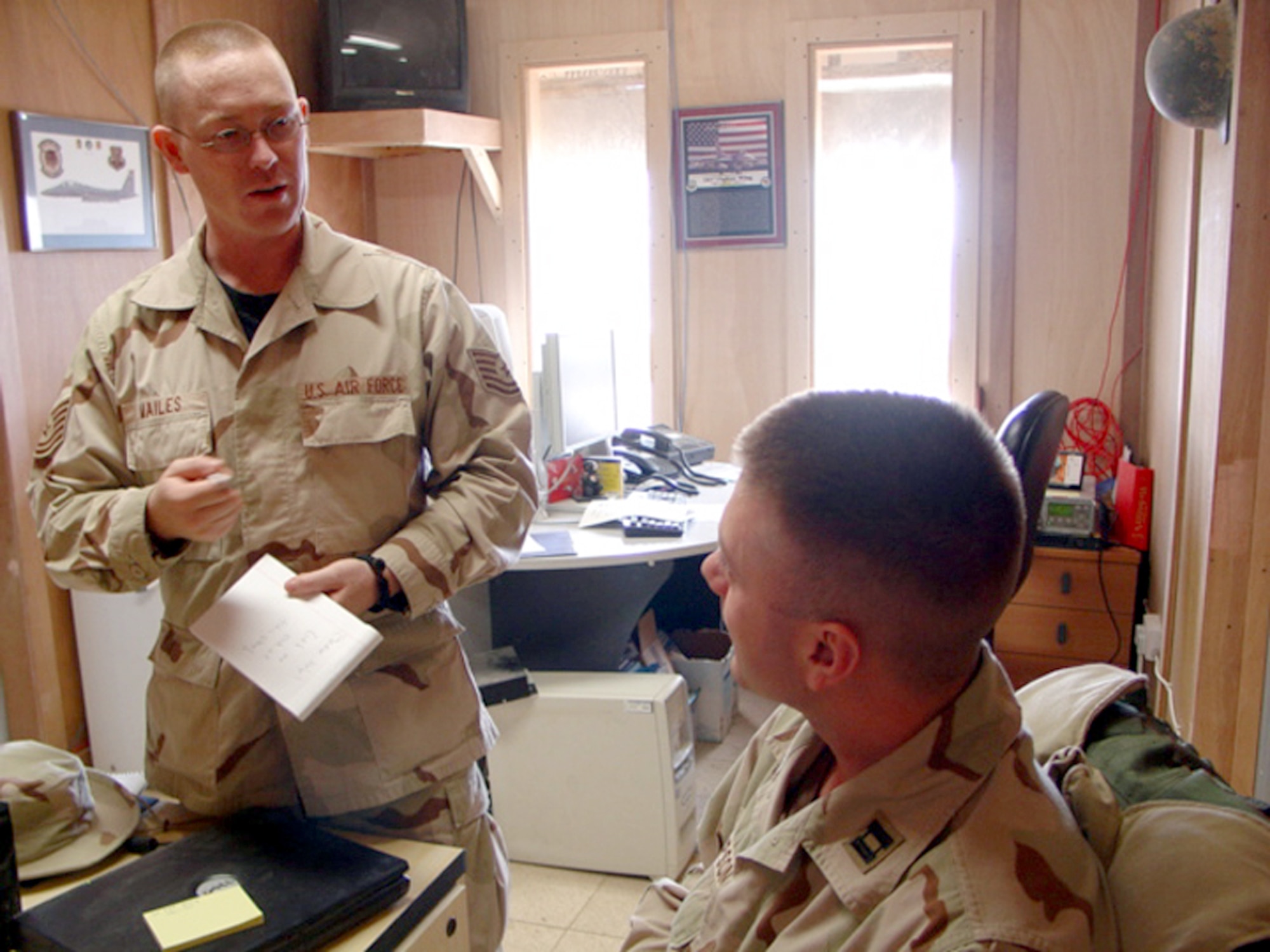 TALLIL AIR BASE, Iraq -- Tech. Sgt. Yancy Mailes (left) interviews Capt. Gary Thompson while compiling a history about the wing's role during Operation Iraqi Freedom.  Sergeant Mailes is the 332nd Air Expeditionary Wing historian and is deployed from Mountain Home Air Force Base, Idaho.  Captain Thompson is the 332nd AEW executive officer and is deployed from Wright Patterson AFB, Ohio.  (U.S. Air Force photo by Staff Sgt. Chris Stagner)