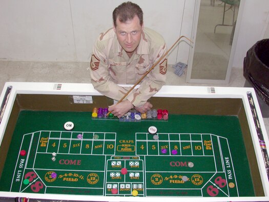 SOUTHWEST ASIA -- Master Sgt. Thomas Shircel of the 386th Air Expeditionary Wing stands over one of the casino tables he helped build for the recreation center at a forward-deployed location.  (U.S. Air Force photo by Senior Airman James C. Dillard)