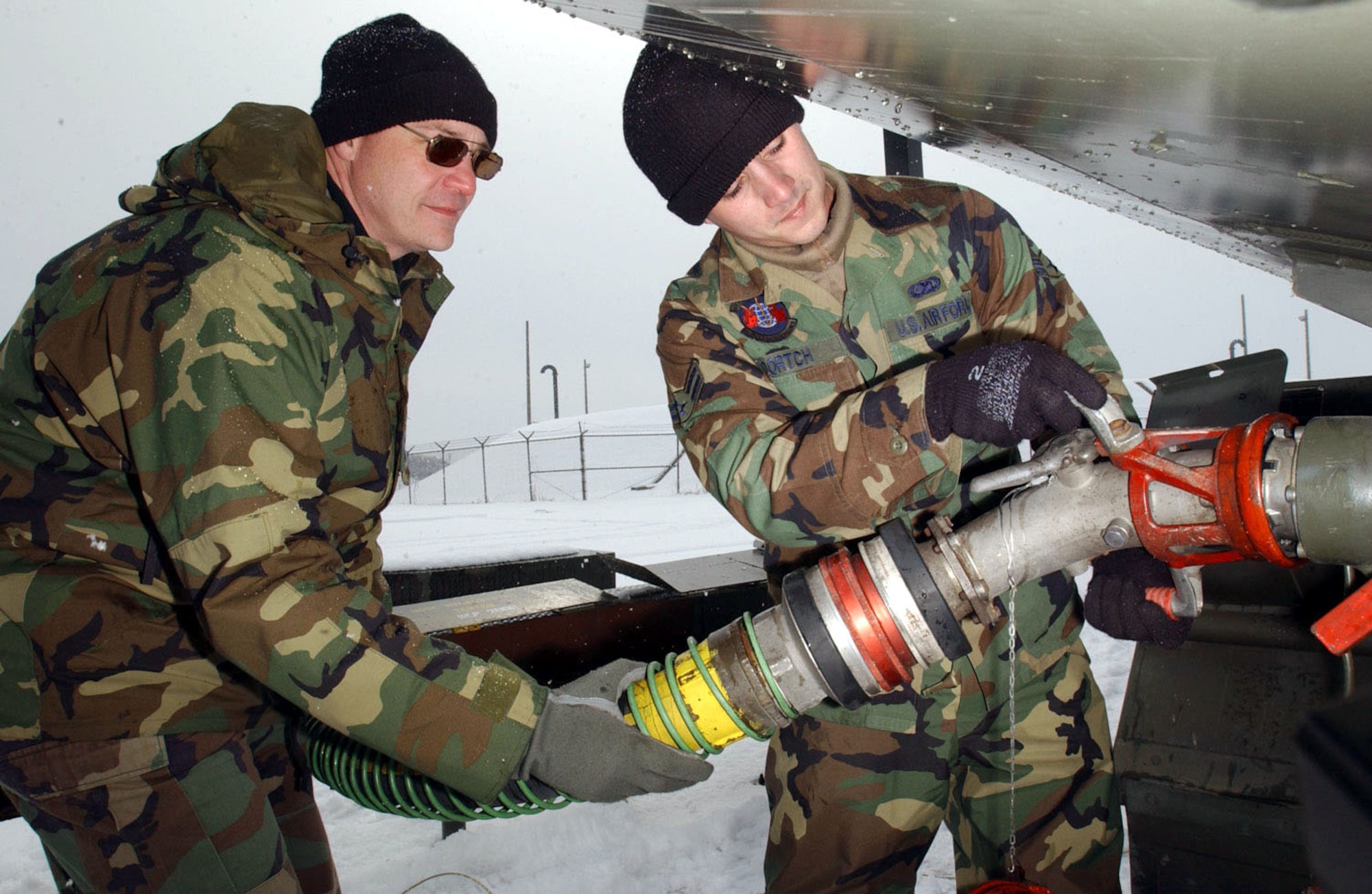 KWANG JU AIR BASE, South Korea -- Master Sgt. Ricky Stone (left) and Airman 1st Class Blake Dortch connect a fuel hose during a four-day deployment here.  Both airmen are assigned to the 18th Logistical Readiness Squadron at Kadena Air Base, Japan.  (U.S. Air Force photo by Tech. Sgt. Richard Freeland)