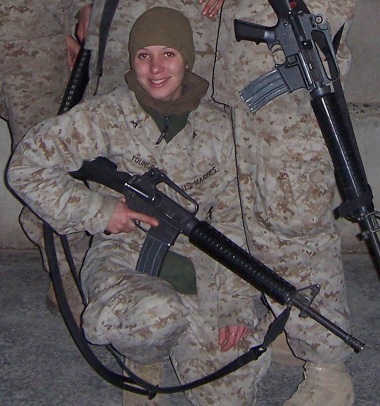 Lance Cpl. Corrine R. Youngbar, food service specialist, Headquarters Battalion, Marine Corps Base Hawaii, Kaneohe Bay, takes time to have someone snap a picture of her as a memento of her deployment to Iraq. Youngbar was deployed to Iraq from September 2004 and returned on March 29th.  Youngbar describes the experience as a good experience that gave her lots of memories.