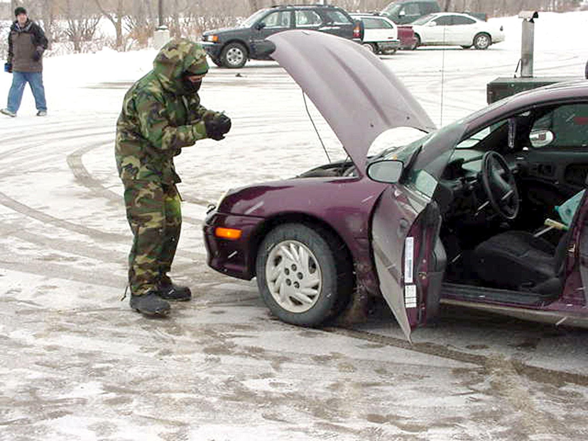 GRAND FORKS AIR FORCE BASE, N.D. (AFPN) -- Senior Airman Lorie Hollis conducts a vehicle inspection at the main gate here.  Airman Hollis is an installation entry controller with the 319th Security Forces Squadron.  (U.S. Air Force photo by Staff Sgt. Scott T. Sturkol)