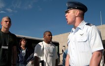 U.S. AIR FORCE ACADEMY, Colo. -- Cadet 1st Class Justin Alberico (right) educates new cadets on the finer points of standing at attention during inprocessing here July 1.  Cadet Alberico and other upperclassman are the primary trainers for new appointees during their indoctrination to the academy and the Air Force.  (U.S. Air Force photo by Tech. Sgt. James A. Rush)