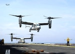 V-22 Osprey aircraft operate in close proximity during recent flight deck developmental testing aboard the amphibious assault ship USS Iwo Jima (LHD 7). The Osprey is a tilt-rotor vertical/short takeoff and landing (VSTOL), multi-mission aircraft developed to fill multi-Service combat operational requirements worldwide.