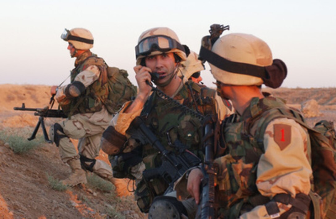 Air Force Lt. Eric Stoutenberg, with the 2nd Brigade Reconnaissance Troop, calls in helicopters to extract his team after completing a Quick Response Force Search and Seizure mission in Iraq on June 26, 2004. The Quick Response Force responds to immediate action situations as directed by the Tactical Operations Center commander. 