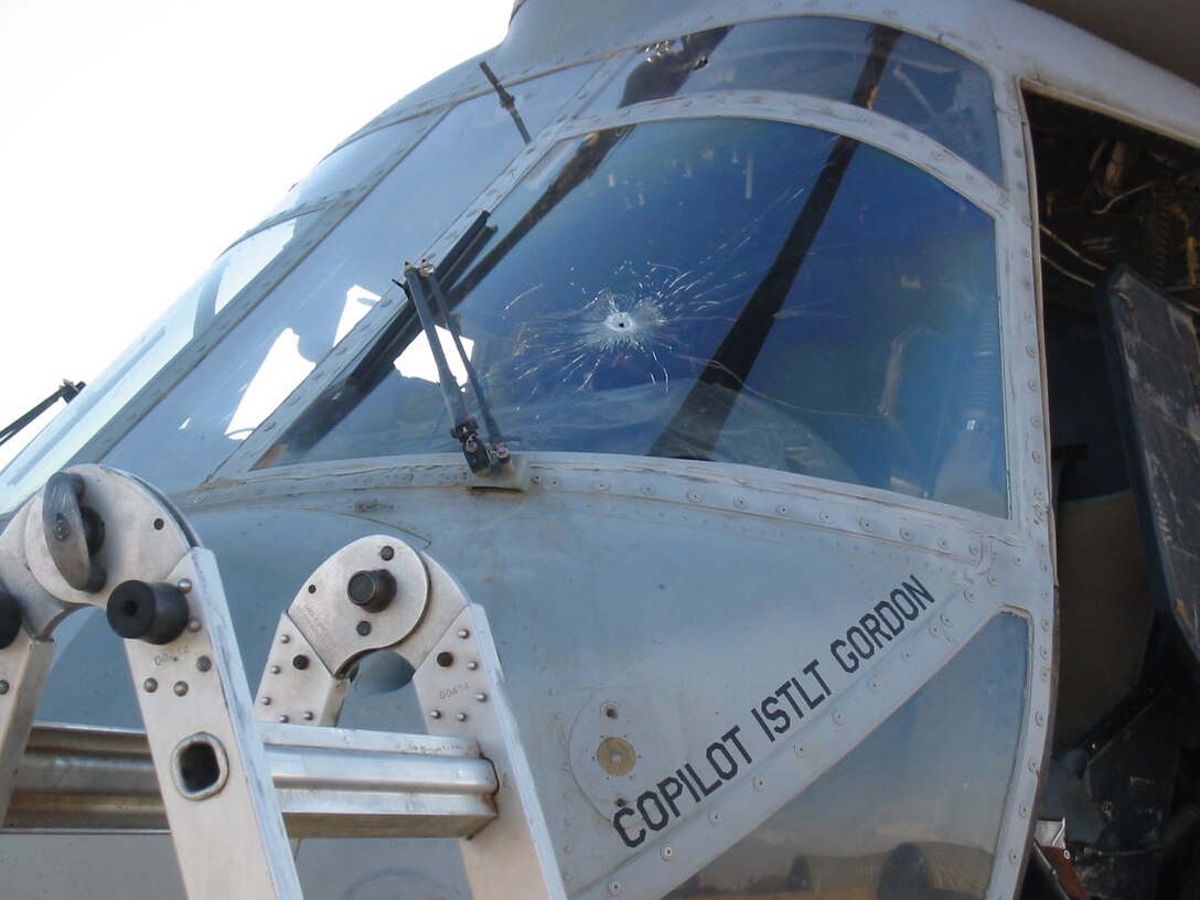 While flying an urgent casualty evacuation mission through enemy fire near Fallujah, Iraq, July 5, 2004, Capt. Steven Clifton, aviation safety officer, Marine Medium Helicopter Squadron 161, Marine Aircraft Group 16, 3rd Marine Aircraft Wing, flew this damaged CH-46E to safety in Al Taqaddum.