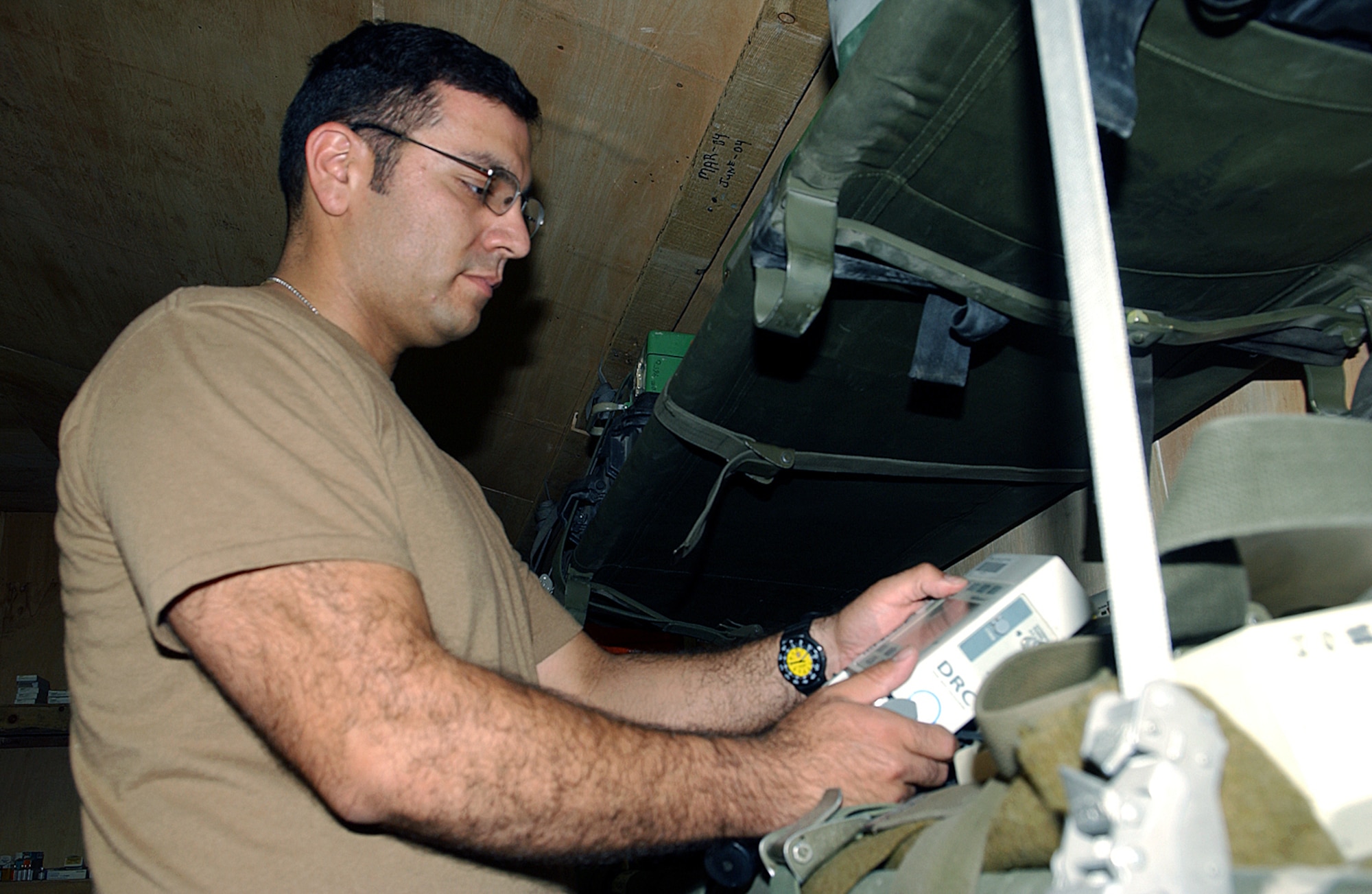 BAGRAM AIR BASE, Afghanistan -- Tech. Sgt. Gabrial Aguilar tests an IV pump before inventorying it for a flight.  The pump is used to run intravenous fluids to a patient while in flight.  Sergeant Aguilar is assigned to the 376th Expeditionary Aeromedical Evacuation Squadron here.  He is deployed from the 349th Aeromedical Evacuation Squadron at Travis Air Force Base, Calif.  (U.S. Air Force photo by Master Sgt. Andrew Gates)  