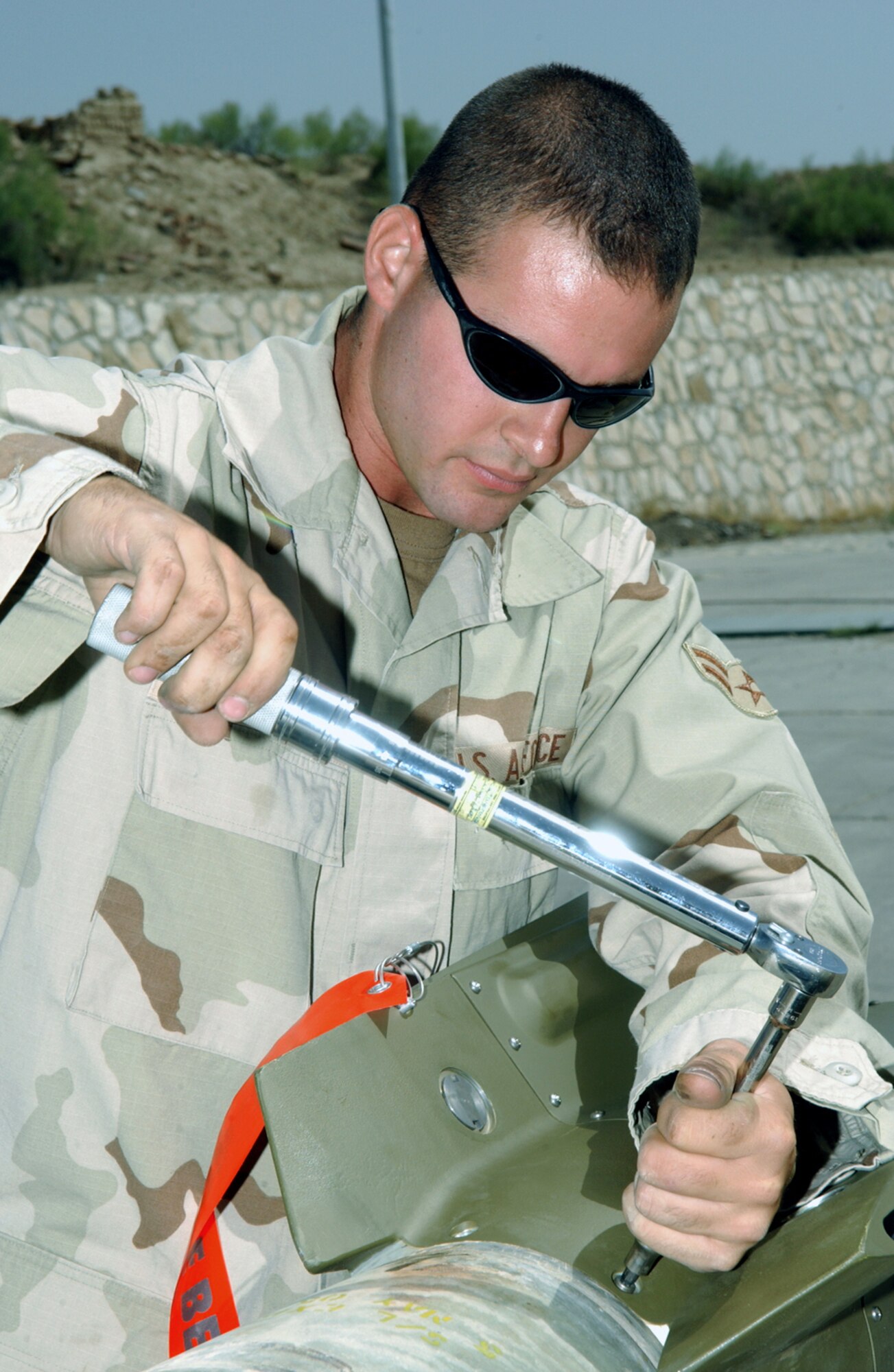 BAGRAM AIR BASE, Afghanistan -- Airman 1st Class Brett Curry attaches a rear fin assembly to a 500-pound laser guided bomb.  He is assigned to the 455th Expeditionary Aircraft Maintenance Squadron and is deployed from Eielson Air Force Base, Alaska.  (U.S. Air Force photo by Master Sgt. Andrew Gates)