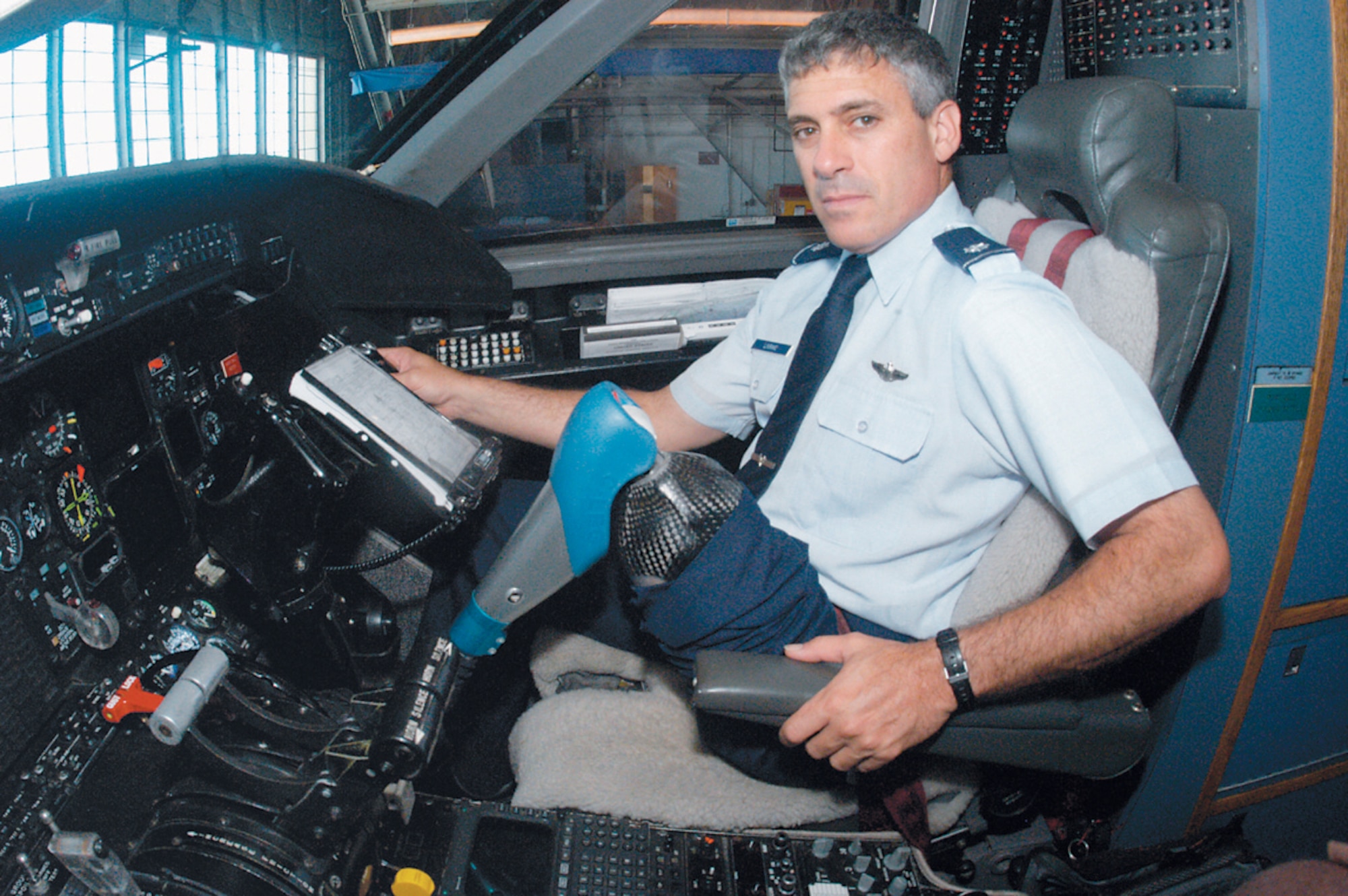 ANDREWS AIR FORCE BASE, Md. -- Lt. Col. Andrew Lourake sits in an Air Force C-20 here. Colonel Lourake underwent an above-the-knee amputation in June 2002. He was medically cleared June 18 to return to flying status and is waiting to attend formal training to get requalified to fly. (U.S. Air Force photo by Bobby Jones)