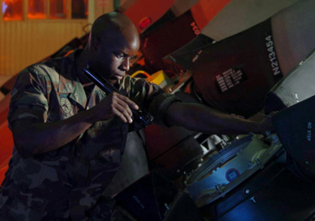 Air Force Senior Airman Brandon Benson uses a flashlight to inspect the interior of a C-130 barrel assembly for cracks during routine check at Yokota Air Base, Japan, on July 1, 2004. Benson is a turbo prop mechanic from the 374th Maintenance Squadron, T56 Engine Regional Repair Center. The center handles all C-130 cargo aircraft engine repair in Pacific Air Forces and provides ready engine and propeller support to guarantee U.S. airlift and special operation presence and crisis response in the region. 