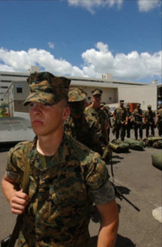 Marines assigned to 3rd Battalion, 3rd Marine Regiment, line up to embark on the USS Tarawa (LHA 1) during Rim of the Pacific Exercise 2004 in Pearl Harbor, Hawaii, on July 5, 2004. Rim of the Pacific is an international exercise that enhances the joint cooperation and proficiency of maritime and air forces of Australia, Canada, Chile, Peru, Japan, Republic of Korea, the United Kingdom and the United States. 