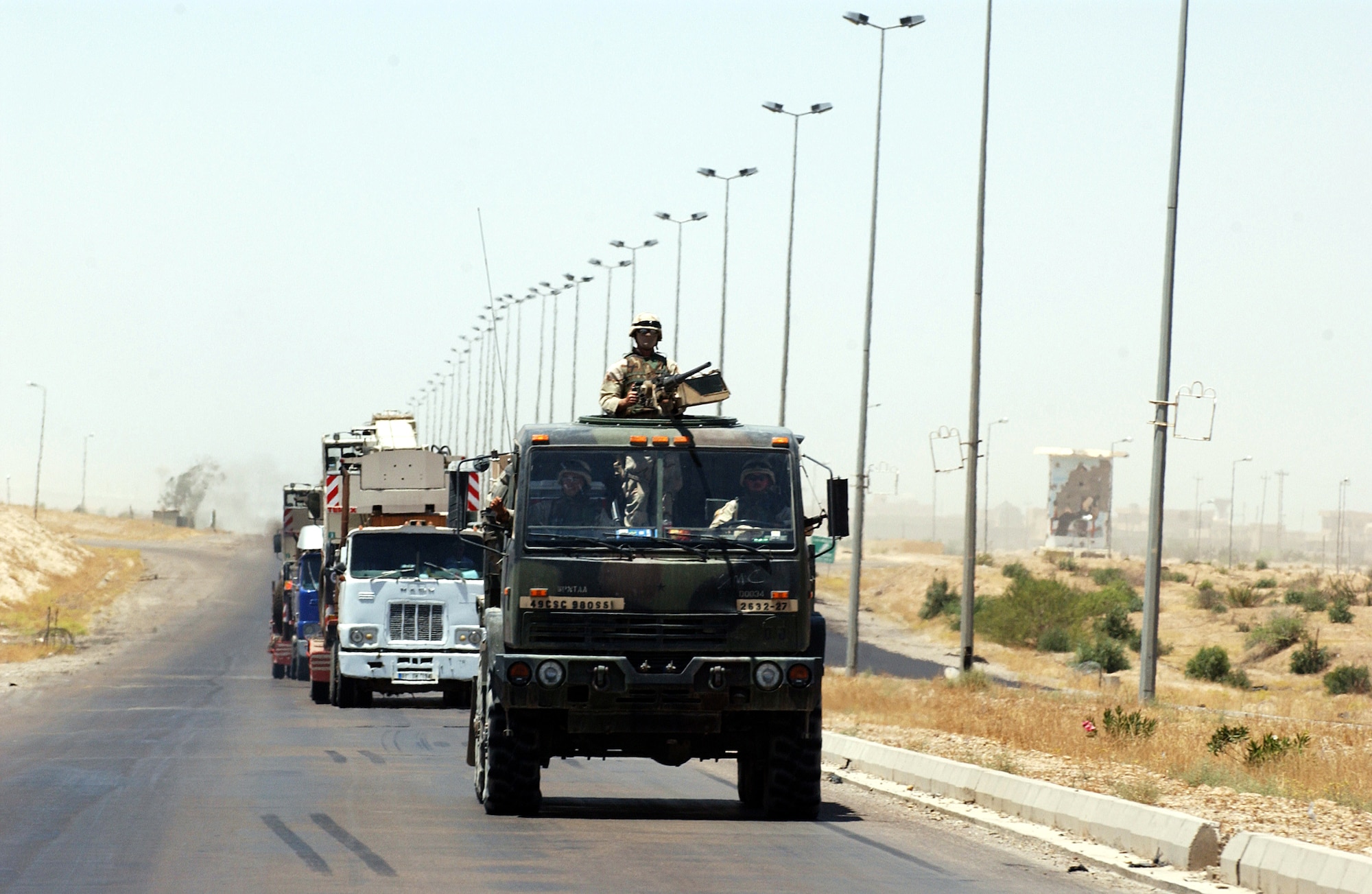 IRAQ -- A gun truck from the 2632nd Air Expeditionary Force Transportation Company moves along the main supply route from Baghdad to Tikrit with a 67-vehicle convoy in tow. The company's Airmen provide security to military and civilian convoys as they move supplies to multiple forward-operating bases throughout Iraq.  (U.S. Air Force photo by Tech. Sgt. Scott Reed)