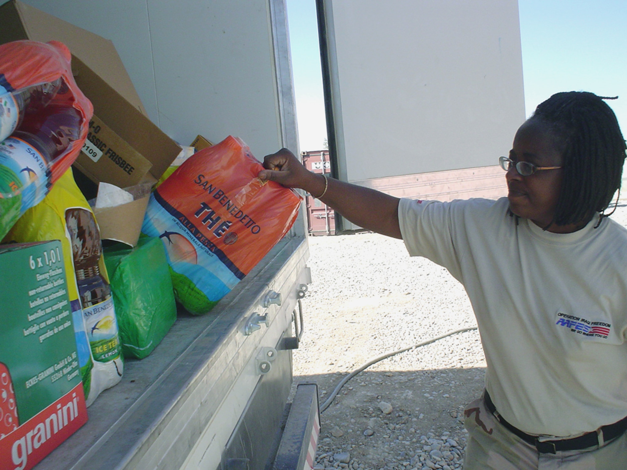 TALLIL AIR BASE, Iraq -- Leconte Heard sorts through items for the Army and Air Force Exchange Service shoppette in Air Force "tent city."  Ms. Heard is one of 12 American AAFES employees here who volunteered to deploy.  (U.S. Air Force photo by Master Sgt. Debbie Aragon)