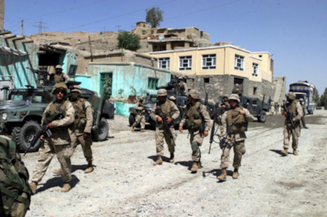 Marines from Company I, 3rd Battalion, 6th Marine Regiment, patrol on foot through downtown Surobi, Afghanistan, on May 23, 2004. The battalion is conducting security patrols and civil assistance operations throughout the region in support of Operation Enduring Freedom. 