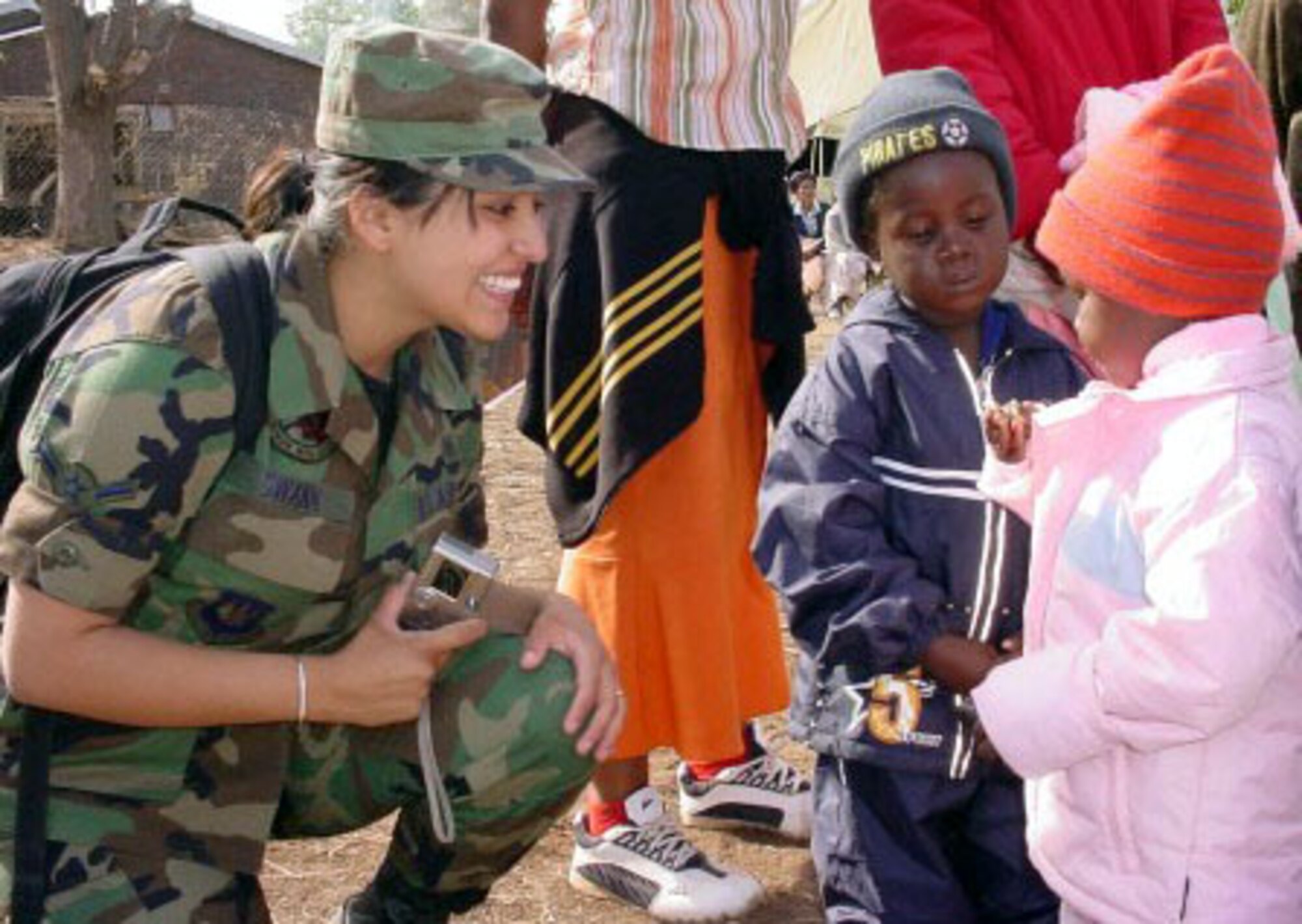 NGWAABE, South Africa -- Airman Angelica Swann talks to young children who are waiting outside the pediatric tent at the clinic here. She is deployed from the 48th Medical Group at Royal Air Force Lakenheath, England.  (U.S. Air Force photo by Master Sgt. Doris Libby)