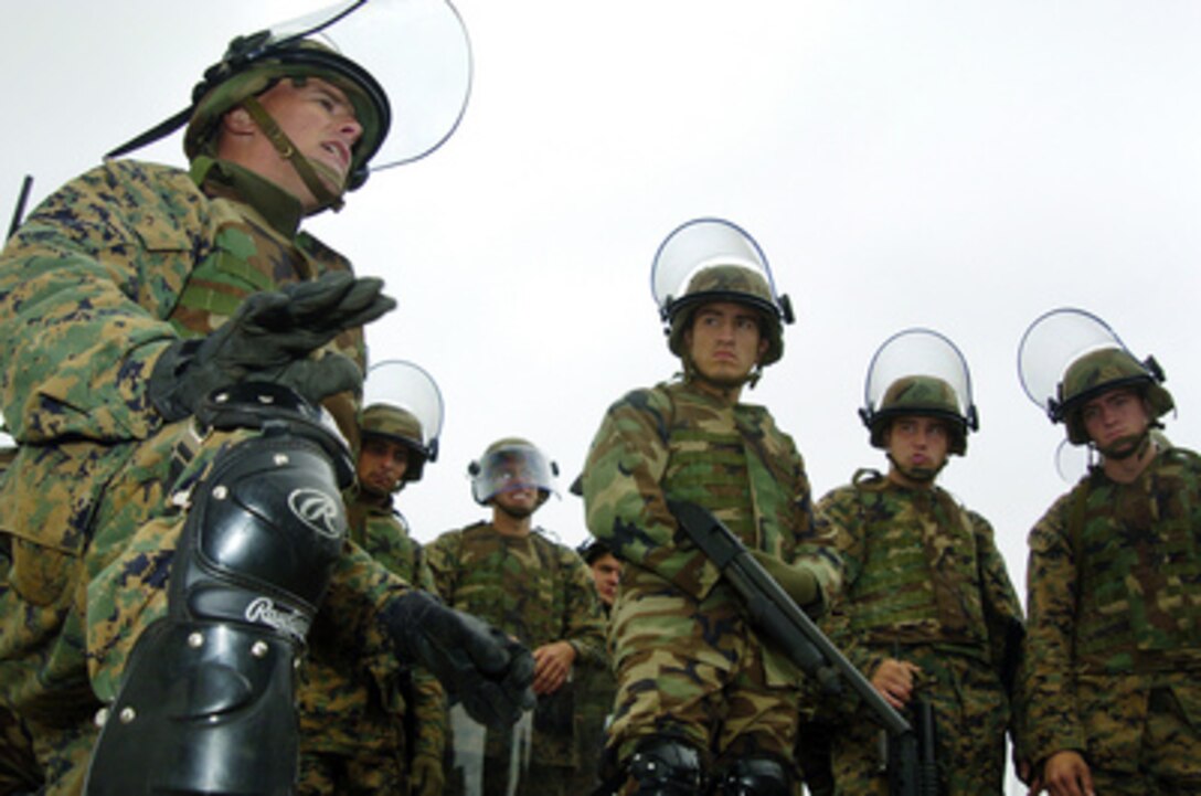 U.S. Marine Corps Capt. Raymond Lopes (far left) instructs his Marines on how to handle rioters during stations training as part of UNITAS 45-04 in Salinas, Peru, on July 7, 2004. UNITAS is an annual training exercise focused on advancing operational capabilities and inter-operations, as well as relations between the U.S. Navy and South American naval forces. 