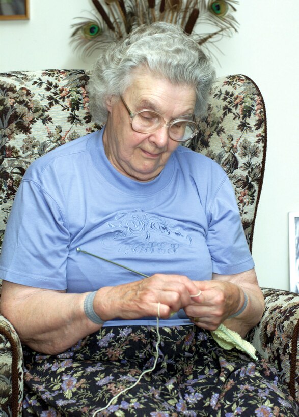 BENWICK, England -- Queenie Vince knits a baby sweater at her home here.  Throughout the past six years, Mrs. Vince has donated about 280 hand-knitted sets of baby clothes to the family support center layette program at Royal Air Force Alconbury, England.  (U.S. Air Force photo by Tech. Sgt. Rich Romero)