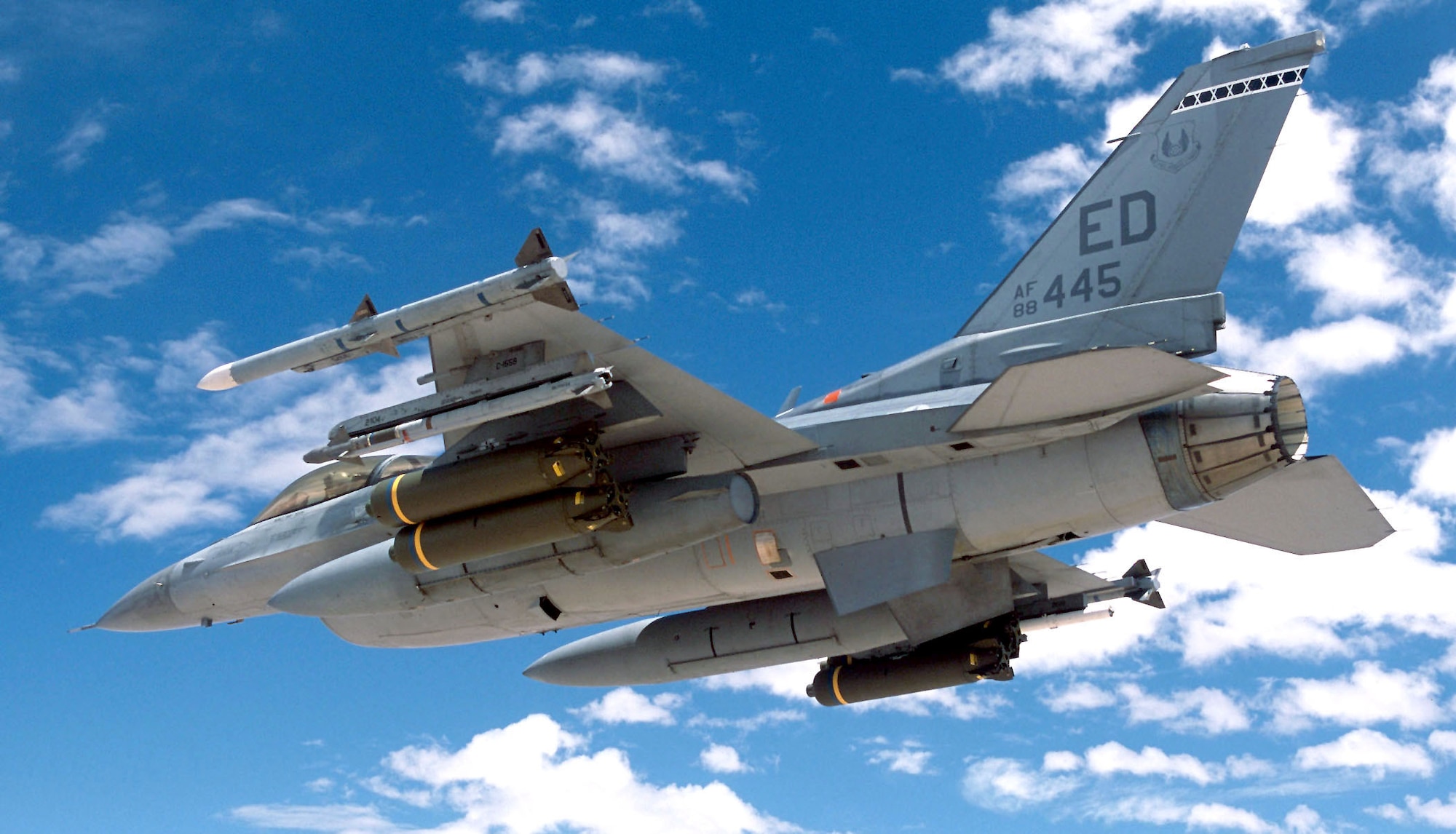 OVER CALIFORNIA -- An F-16 Fighting Falcon flies near China Lake Naval Air Weapons Center, Calif., during a successful AIM-9X test.  The aircraft and pilot are from the 416th Flight Test Squadron at Edwards Air Force Base, Calif.  (Photo by Tom Reynolds)