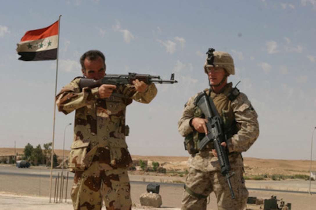 U.S. Marine Corps 1st Lt. Lee (right) with India Company, 3rd Battalion, 4th Marines, 1st Marine Division, instructs an Iraqi Civil Defense Corps solider in weapons handling on the roof of a command post outside Anah, Iraq, on June 11, 2004. The 1st Marine Division is deployed in support of Operation Iraqi Freedom and engaged in Security and Stabilization Operations in the Al Anbar Province of Iraq. 