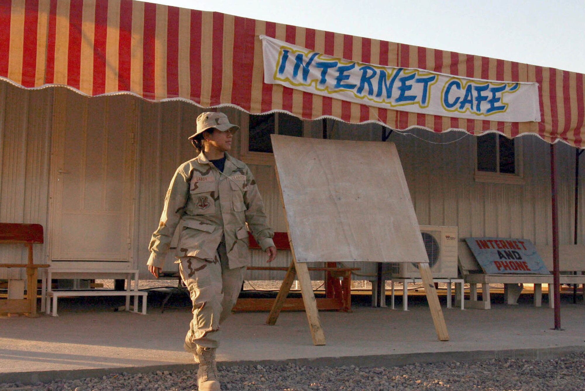 BAGHDAD, Iraq -- Airman 1st Class Vanessa Laboy finishes using an Internet café in the 1st Cavalry area of Camp Victory here.  Air Force communications teams are helping support one of more than 180 Internet cafes throughout Iraq.  (U.S. Air Force photo by Master Sgt. Karen Petitt)